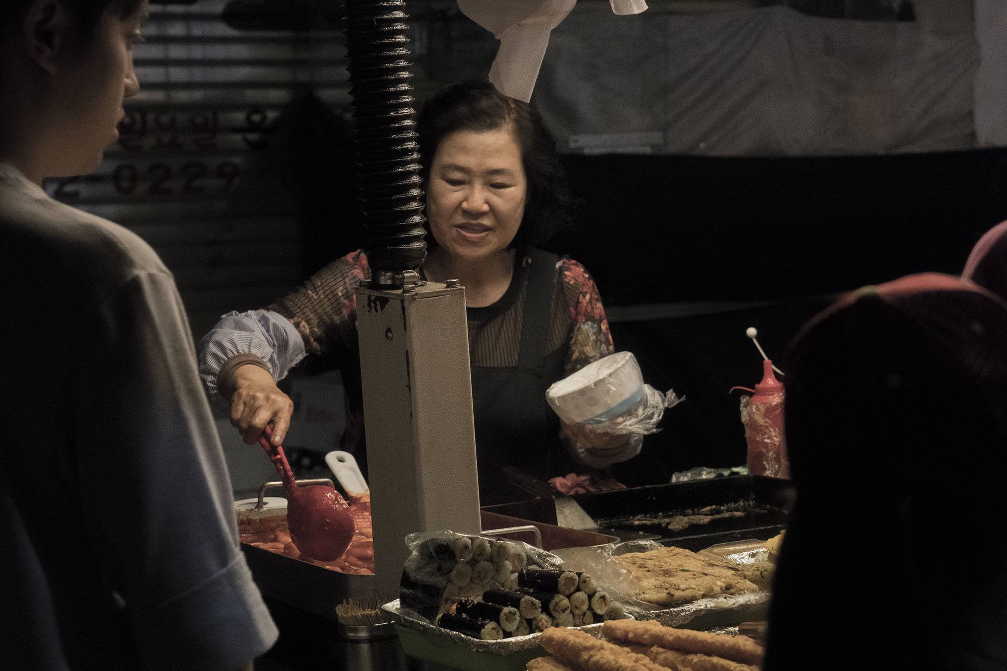 Women serving food at stall of Namdaemun Market Seoul Republic of Korea