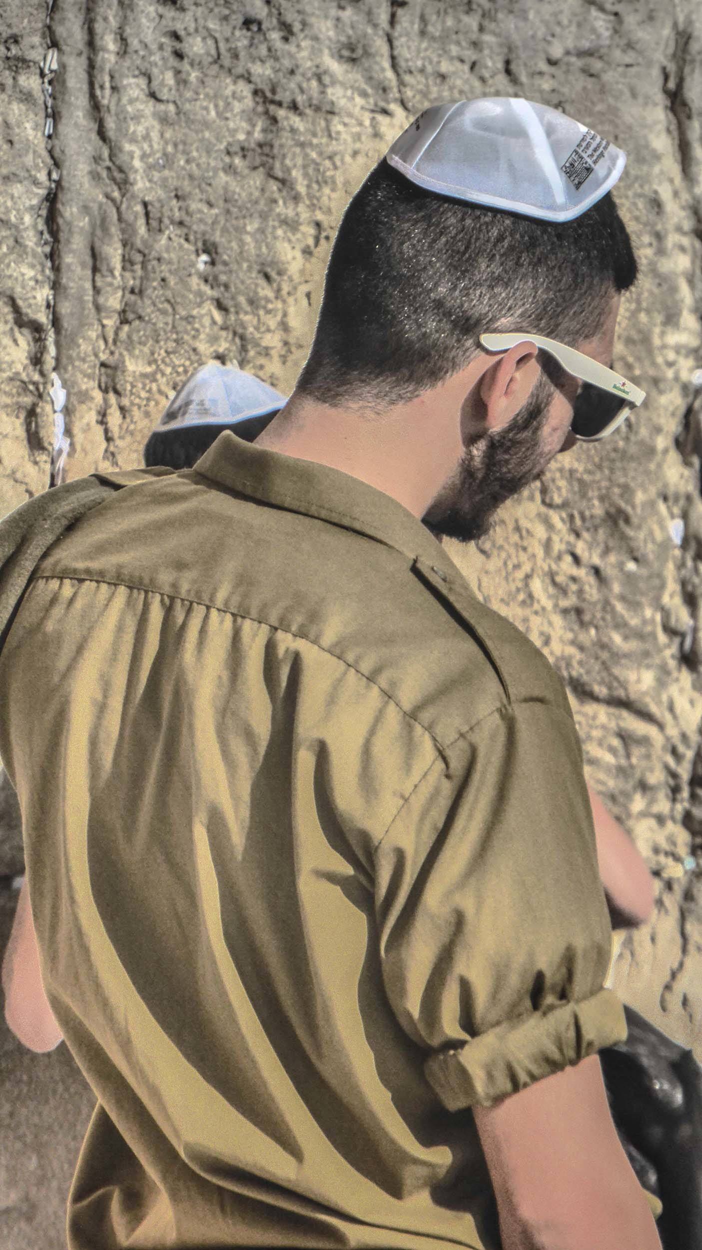 Young Jewish soldier at wailing wall in Jerusalem Israel