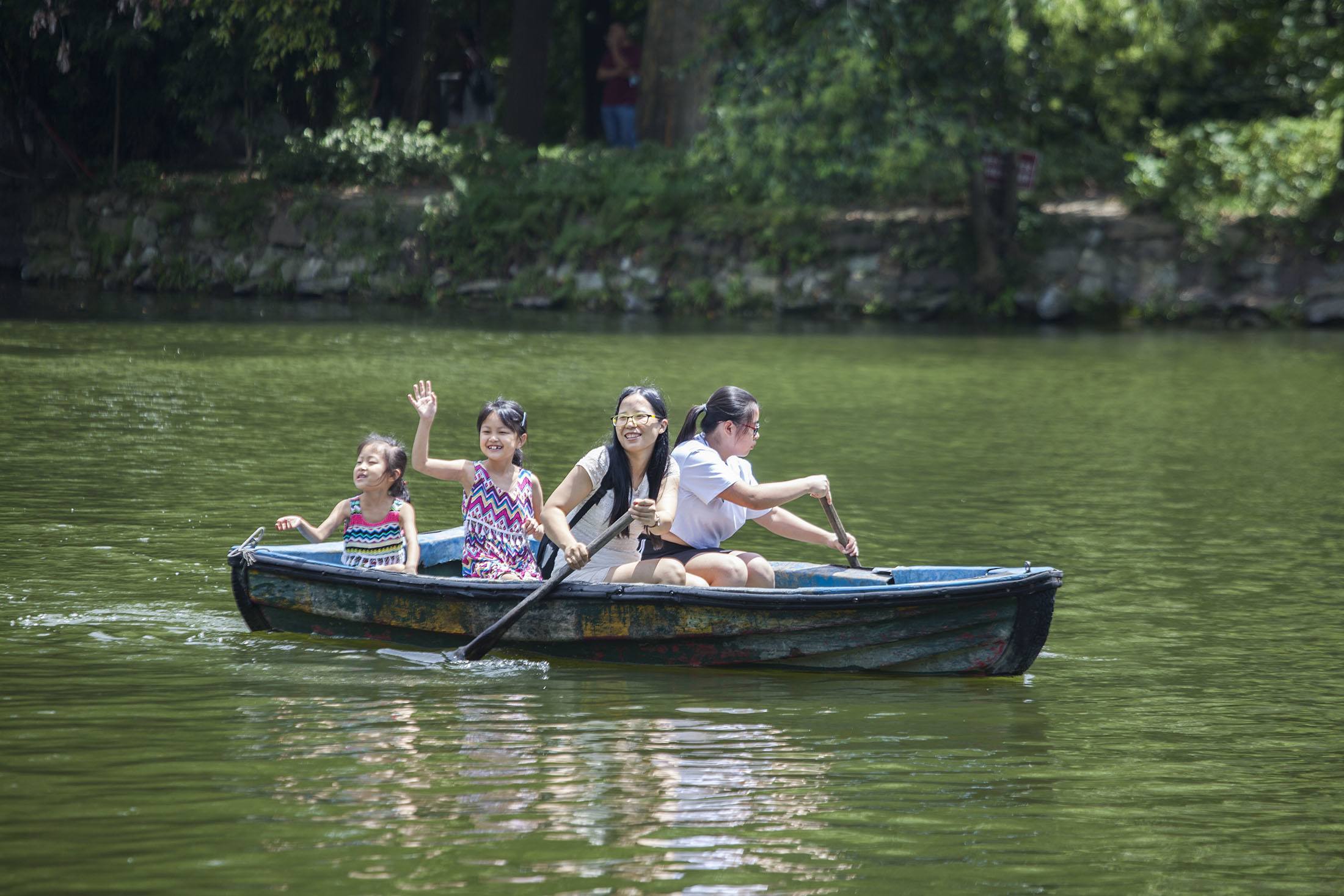 A Chinese family rowing in Renmin Park Lake Chengdu China