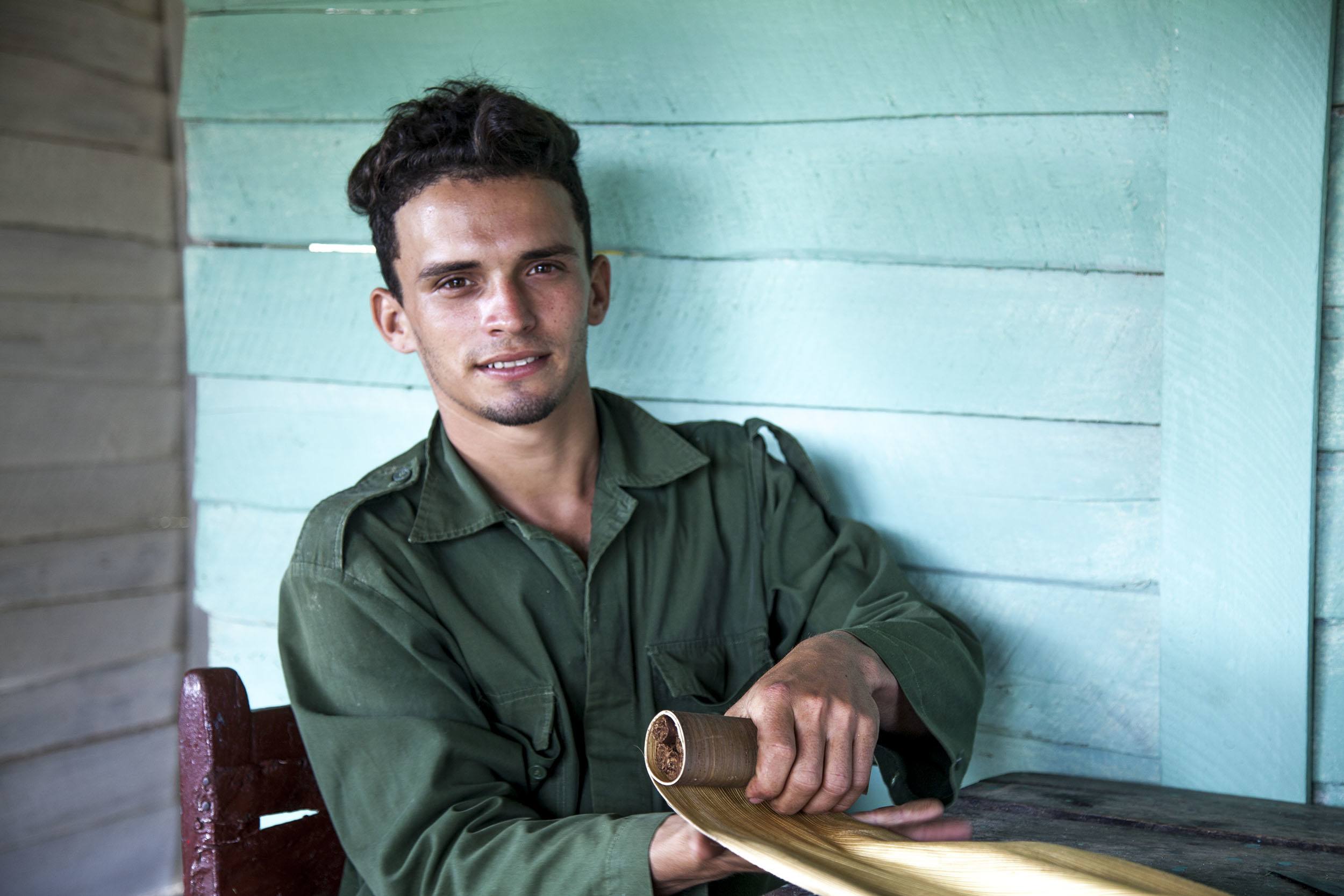 A Cuban man in the hills of Vinales rolling tobacco Cuba