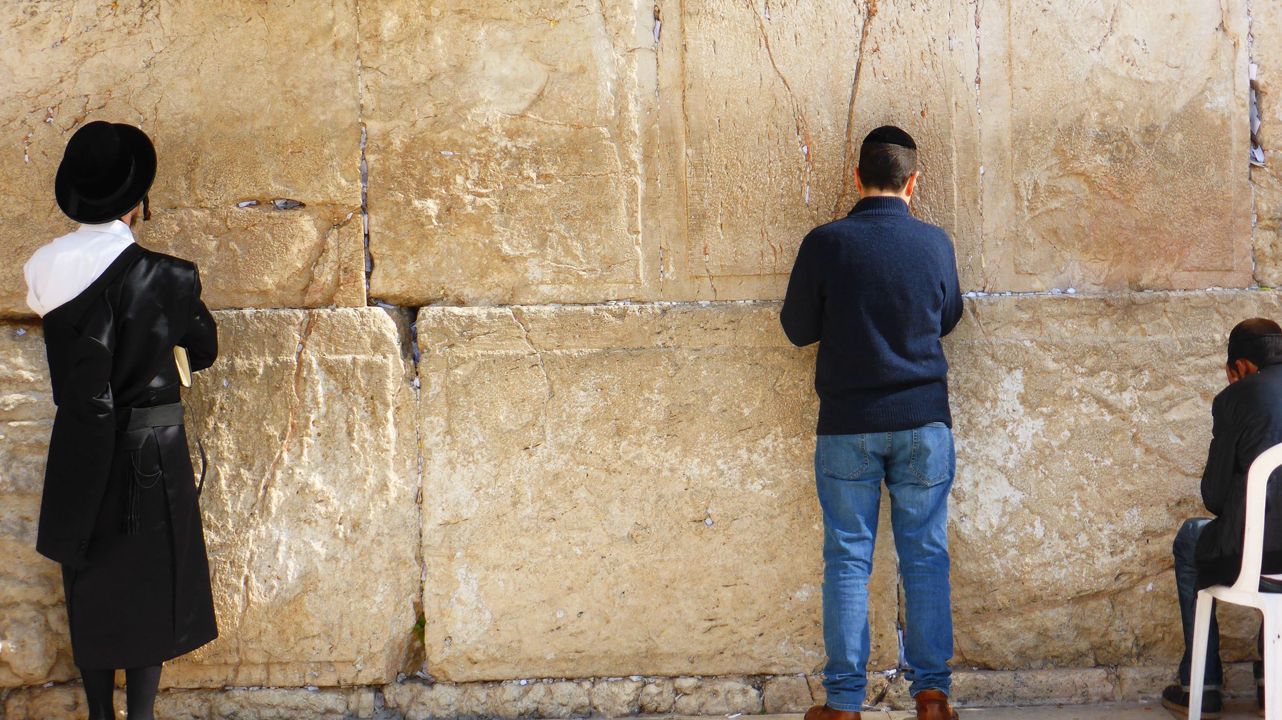 A few men at the wailing wall in Jerusalem Israel