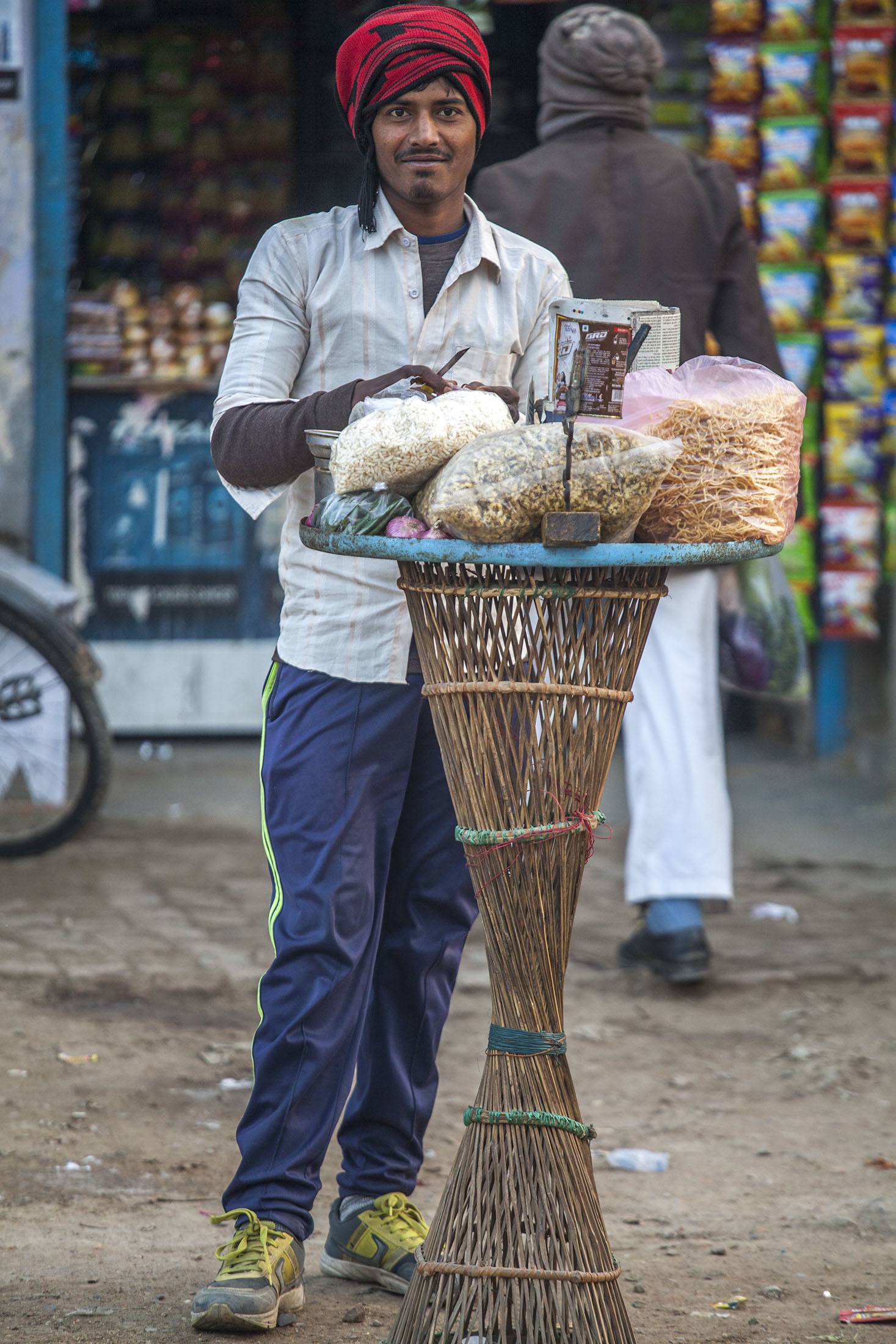 A man selling snacks by the road in Ghazipur India