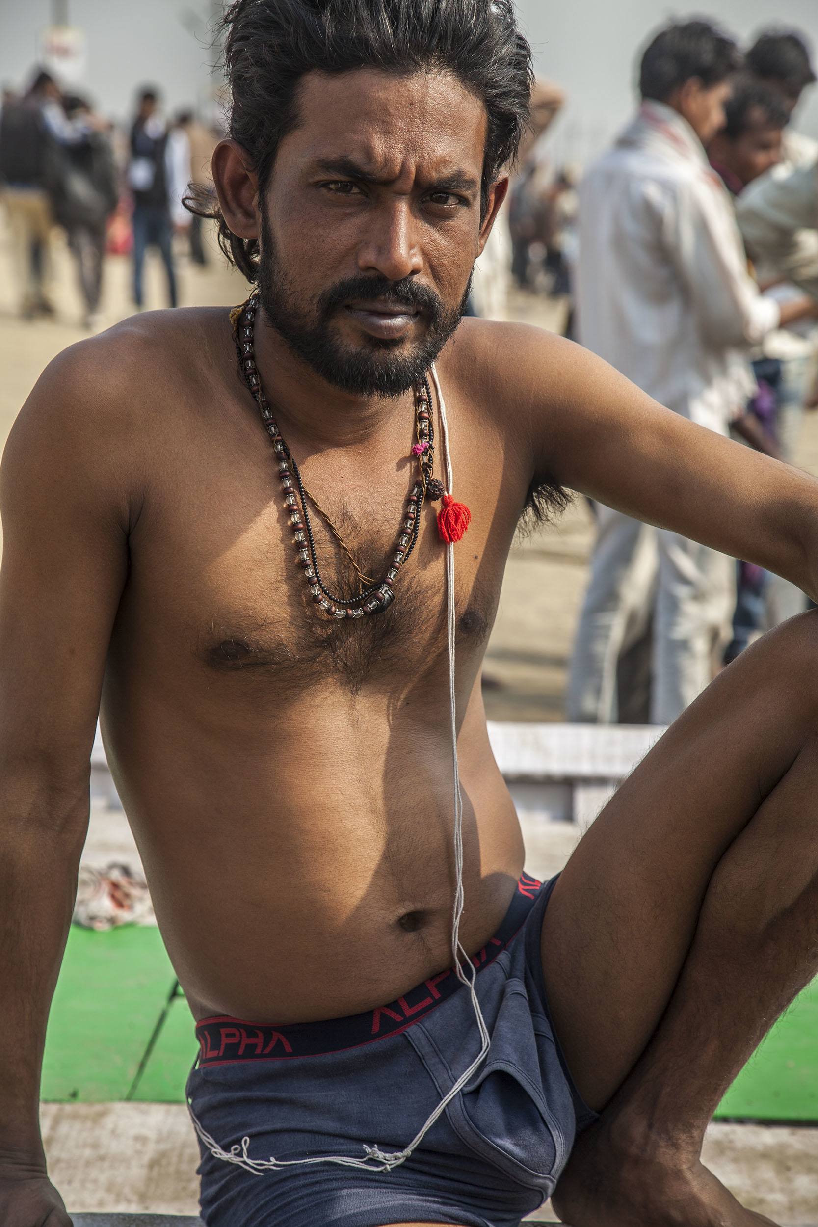 An Indian man sitting on a boat by the Ganges at Marg Melah Allahabad India