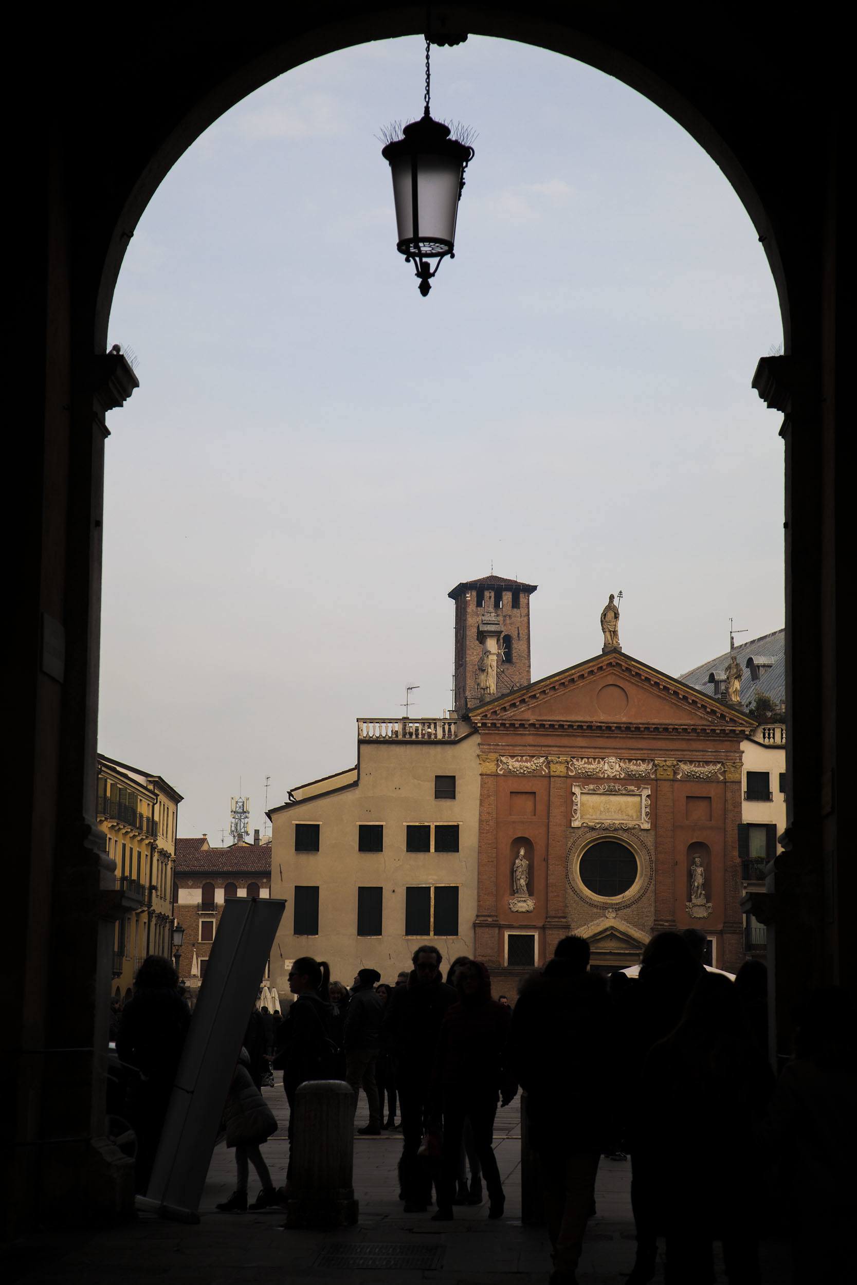 An arch in a wall leading to a piazza in Padova Italy