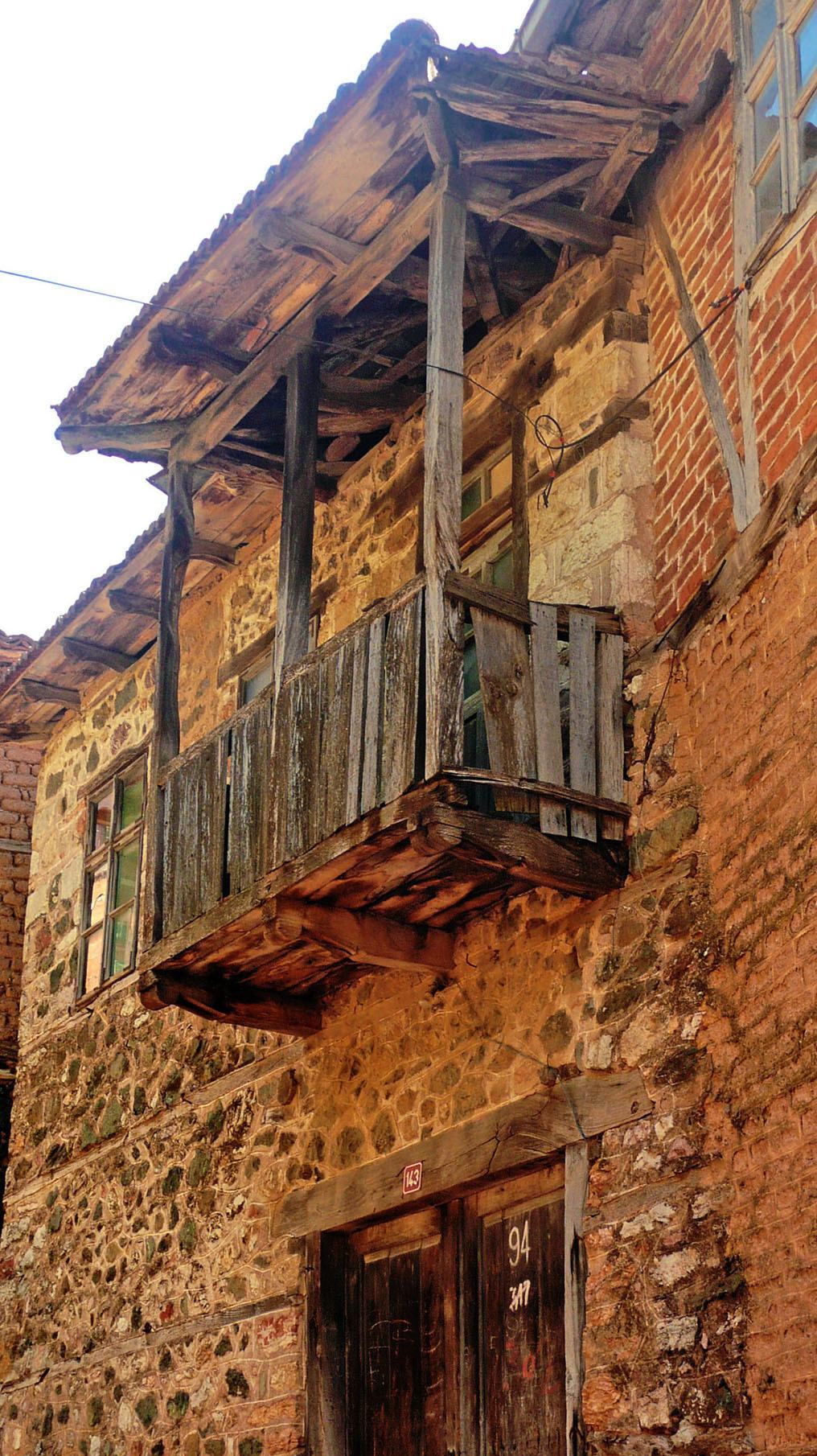 An old building with a wooden verandah in Vevcani North Macedonia