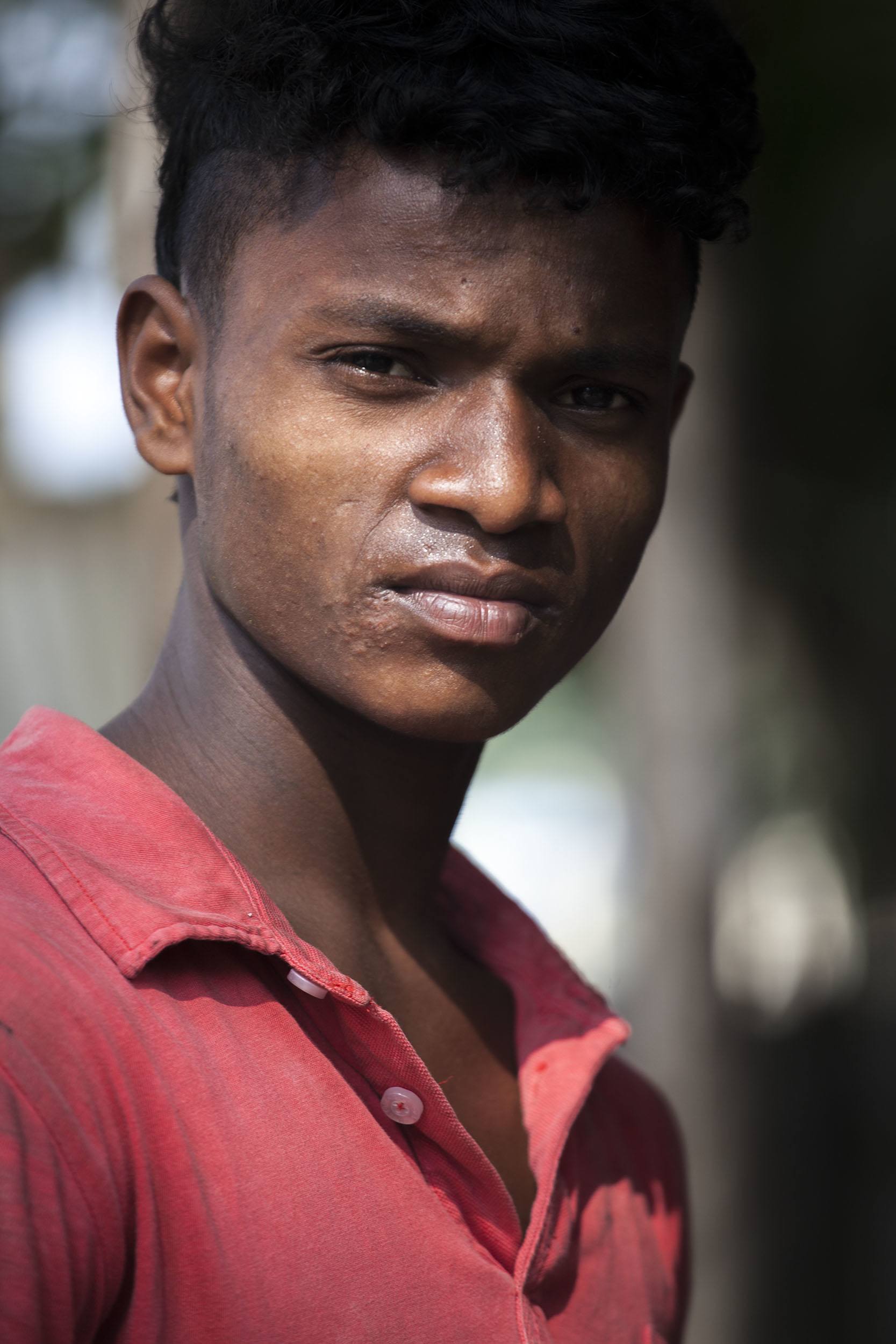 Bangladeshi man in red shirt with a serious look Srimangal Bangladesh