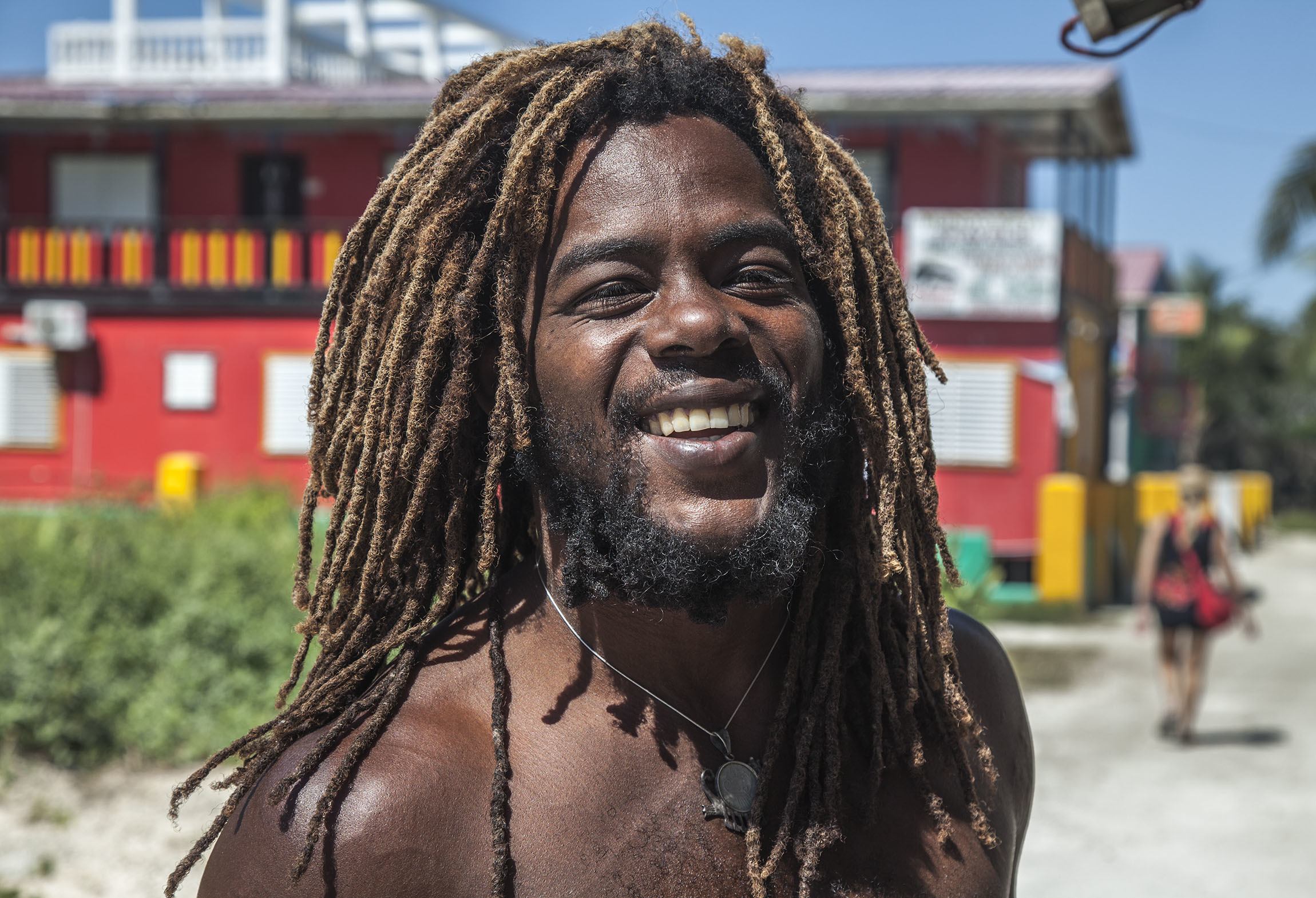 Belizean man with dreadlocks smiling on Caye Caulker Belize