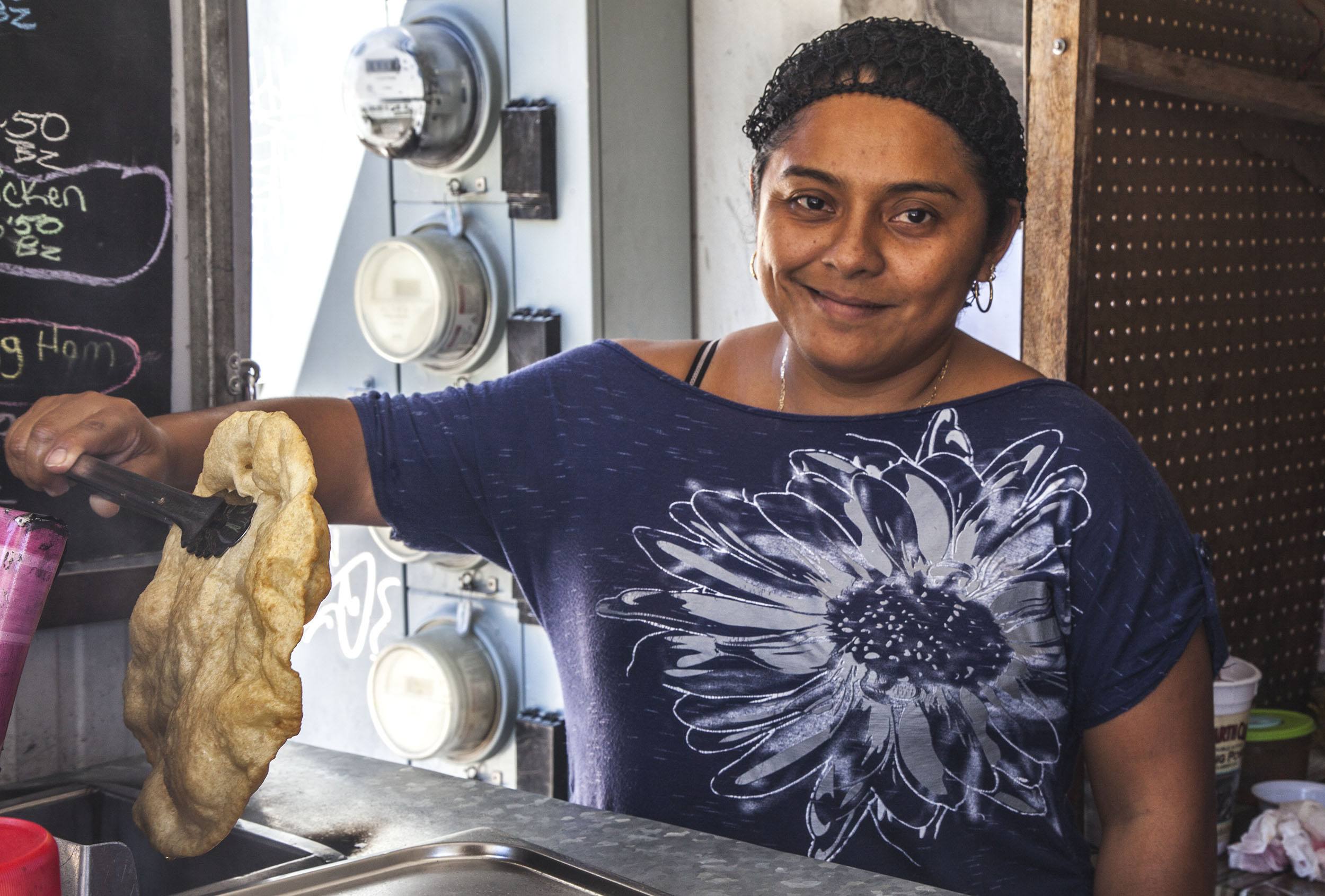 Belizean woman cooking fast food on Caye Caulker Belize