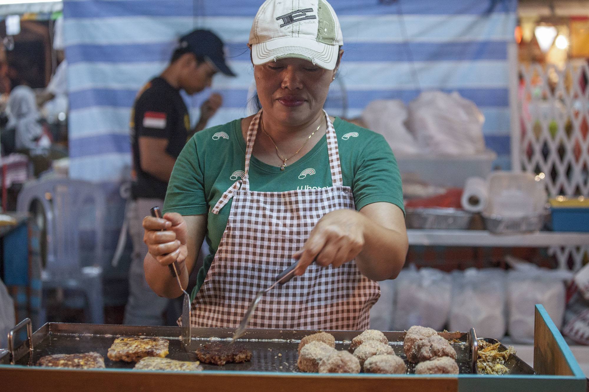 Bruneian woman cooking at night market in Bandar Seri Begawan Brunei Darussalam