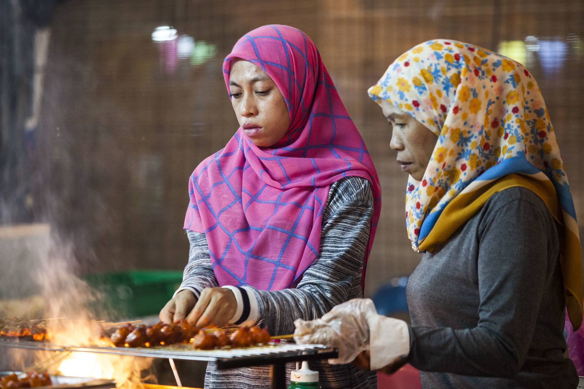 Bruneian women cooking at night market in Bandar Seri Begawan Brunei Darussalam