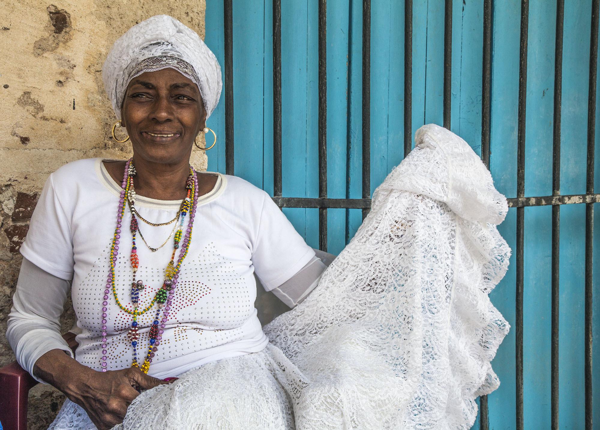 Cuban woman sitting in piazza in Havana Cuba