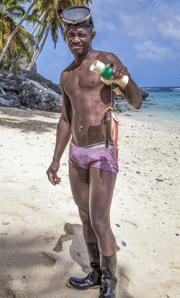 Dominican man with a fresh catch of fish on Playa Madama Dominican Republic photography page