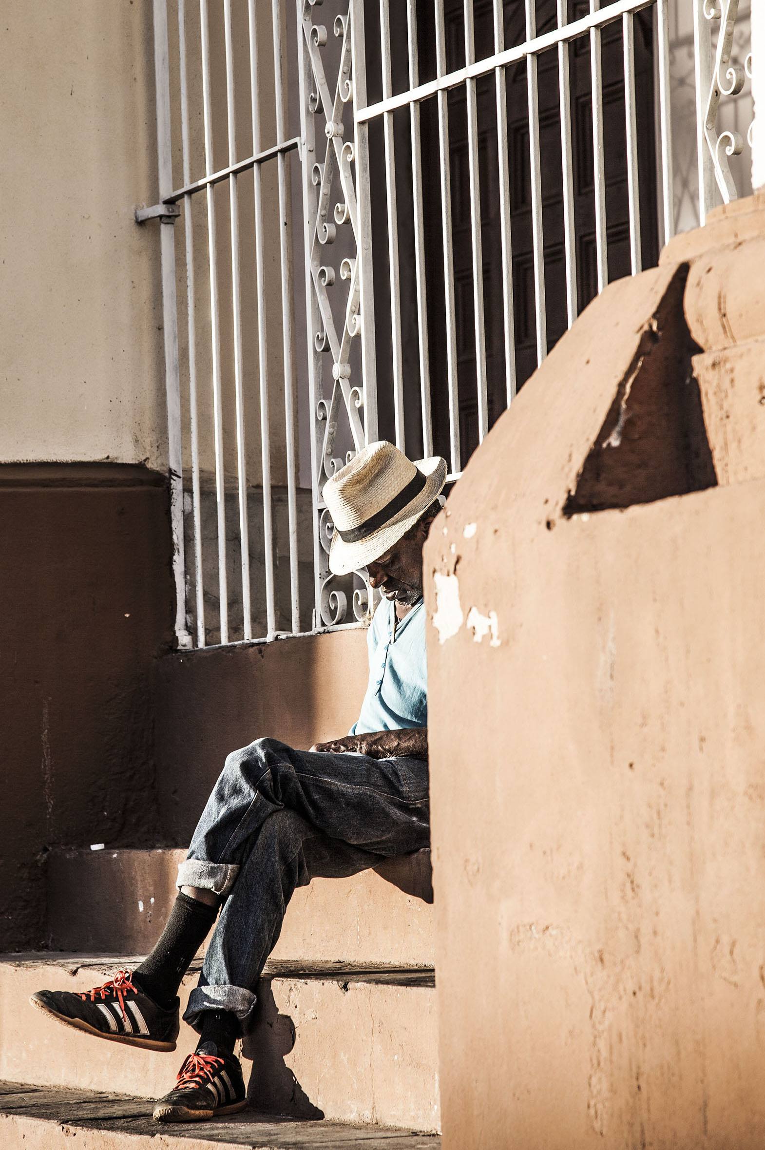 Elderly man resting outside church in Trinidad Cuba