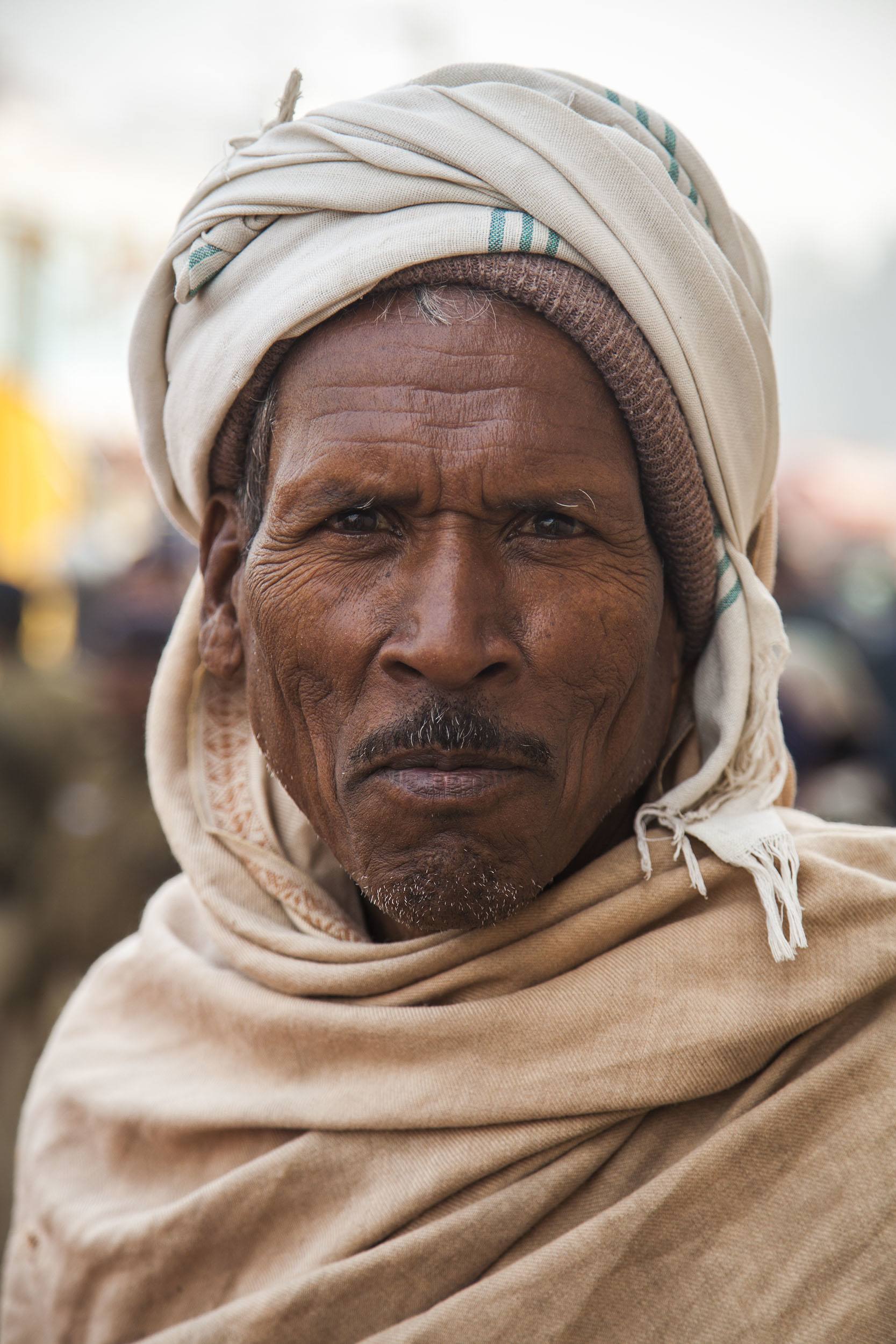 Indian man wearing beanie and scarf on his head at the Lifeline Express in Ghazipur India