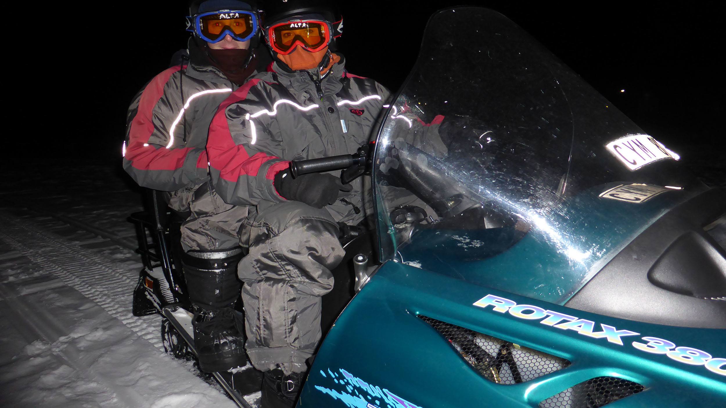Kylie and Ben on a snowmobile outside the Ice Hotel in Sweden