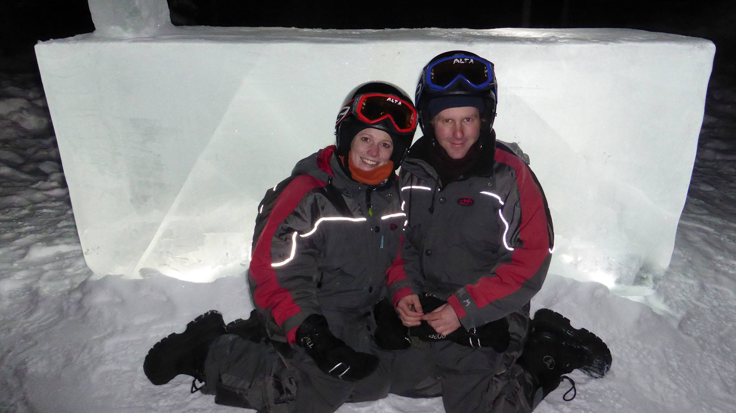 Kylie and Ben posing in front of a large block of ice at the Ice Hotel in Sweden