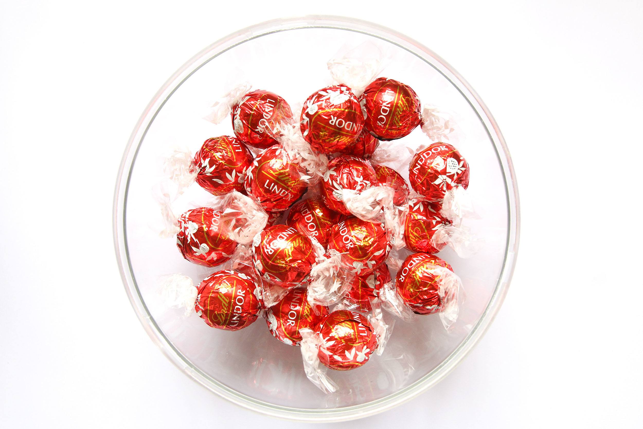 Lindt Swiss chocolates in a glass bowl on a bench