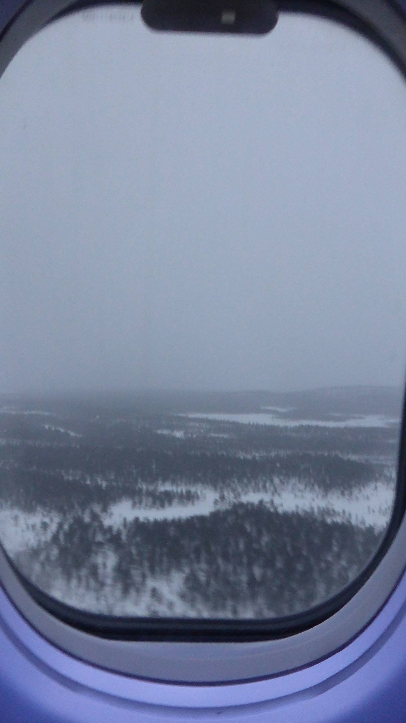 Looking through plane window coming in to land at Kiruna Airport in Sweden