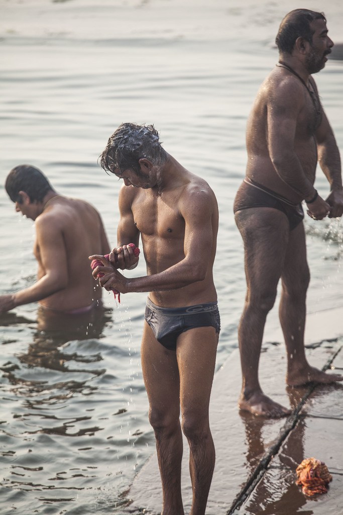 Man bathing and washing clothes in the Ganges Varanasi India