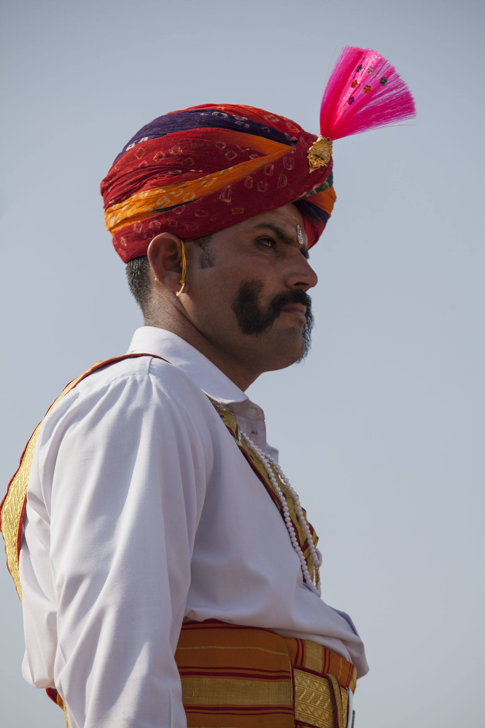 Man in colourful turban celebrating the Jaisalmer Desert Festival in India