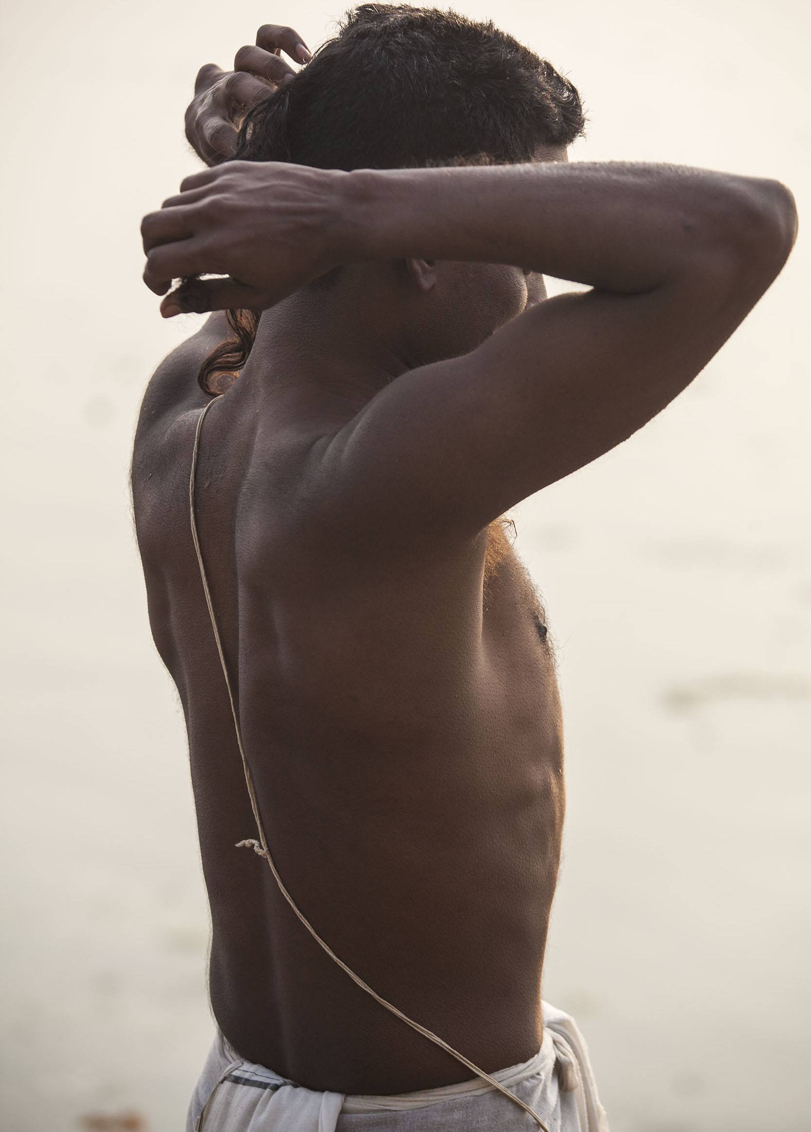 Man in white lungi after bathing in the Ganges in Varanasi India