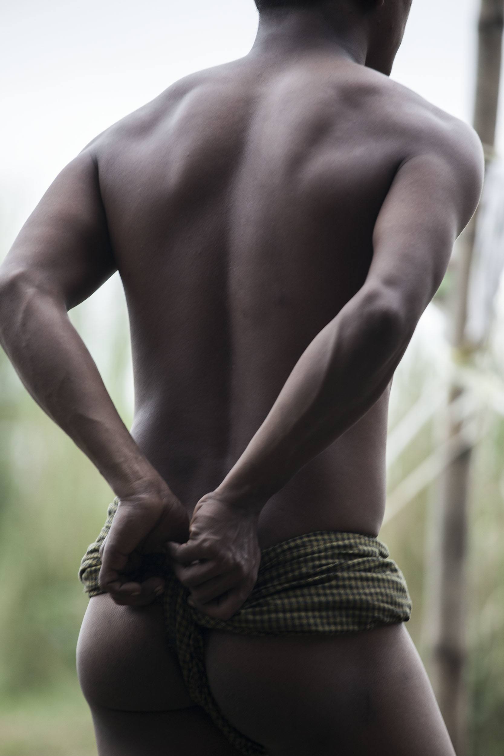 Man playing with his longyi during a game of Chinlone in Myanmar