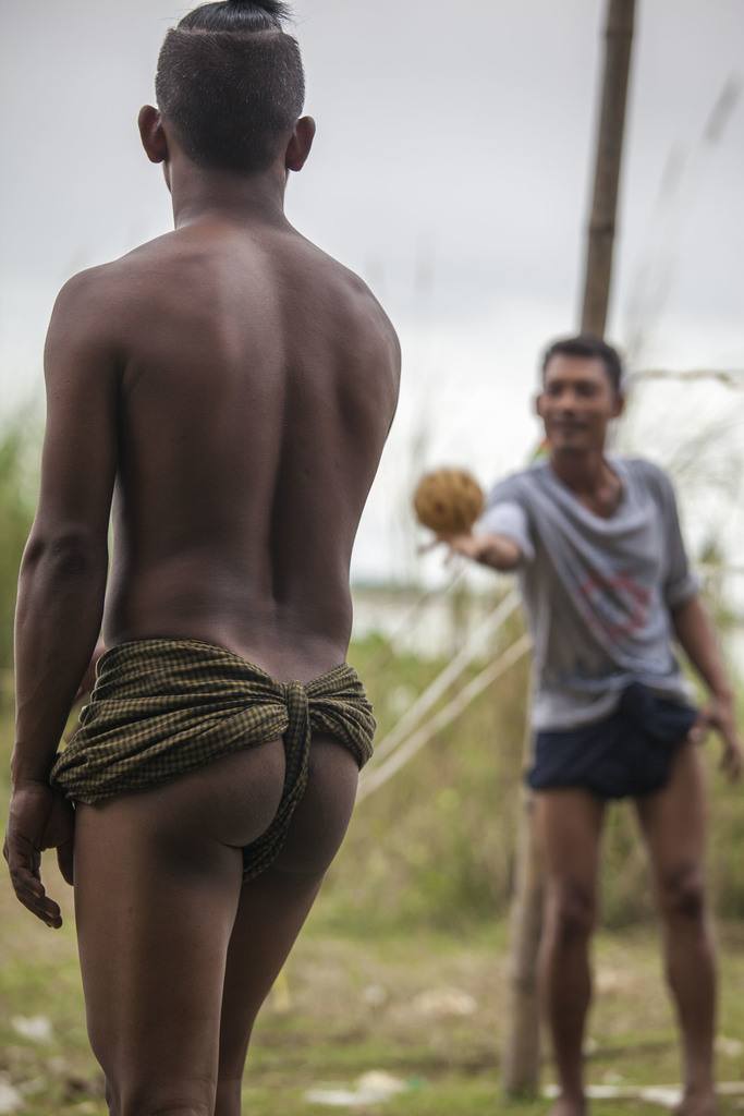 Man wearing longyi as underwear during Chinlone game in Mingun Myanmar