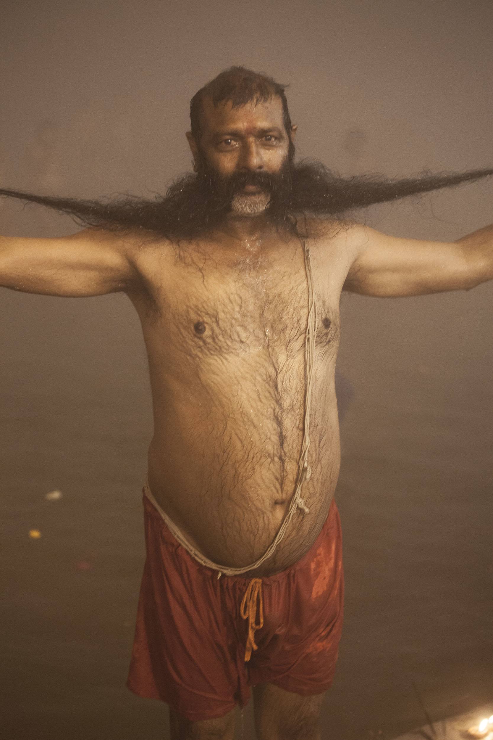 Man with long moustache swimming in the Ganges at Marg Melah in Allahabad