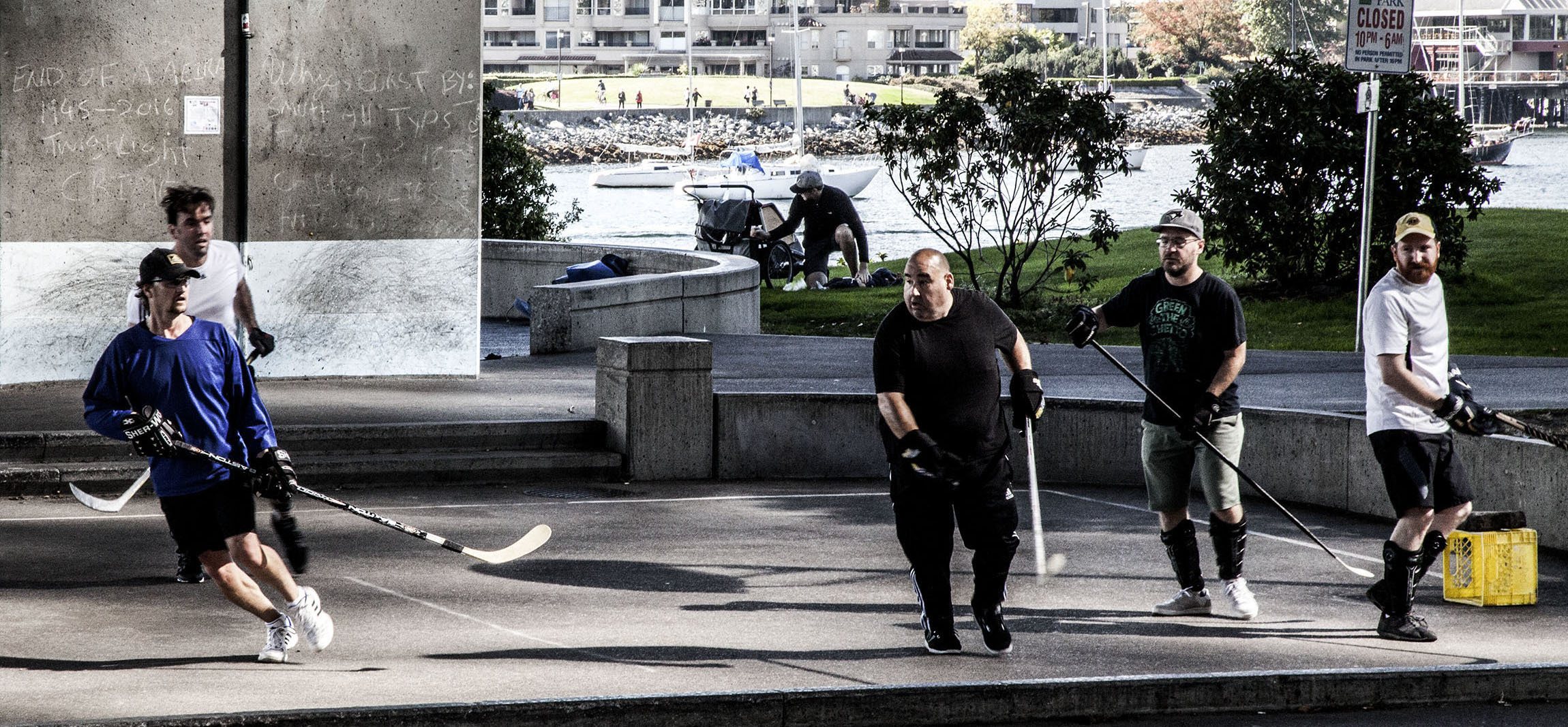 Men playing hockey in the street in Vancouver Canada