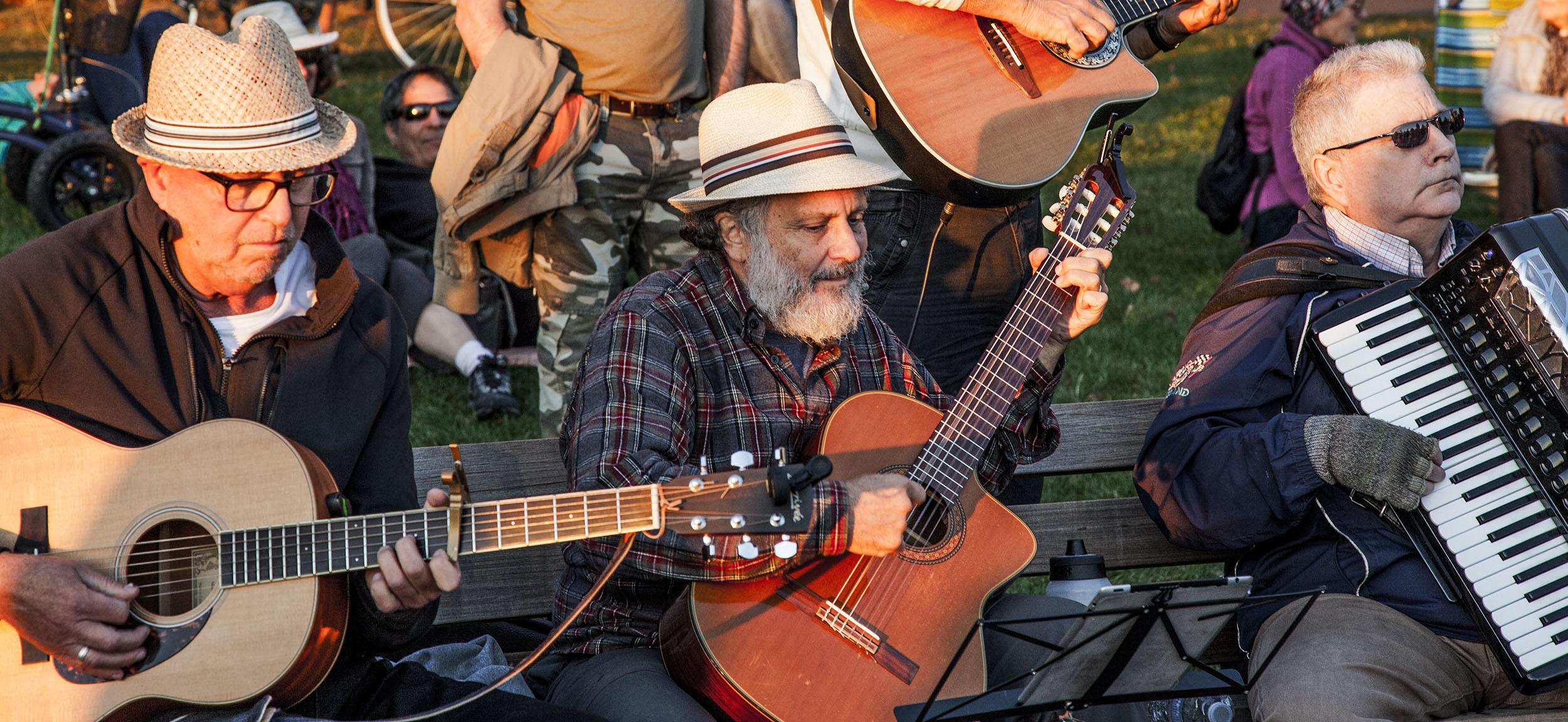 Men playing music in a park in Vancouver Canada