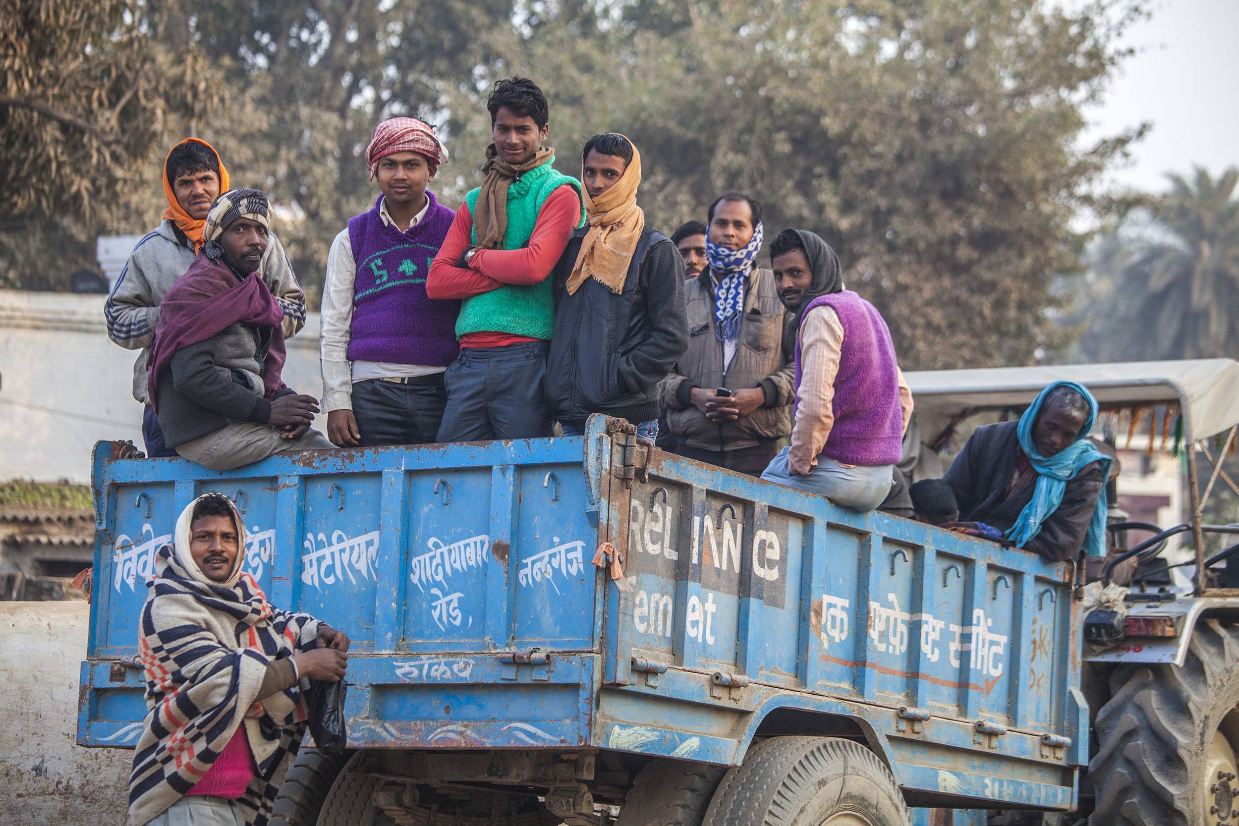 Men standing in the tray of a tractor in Ghazipur India