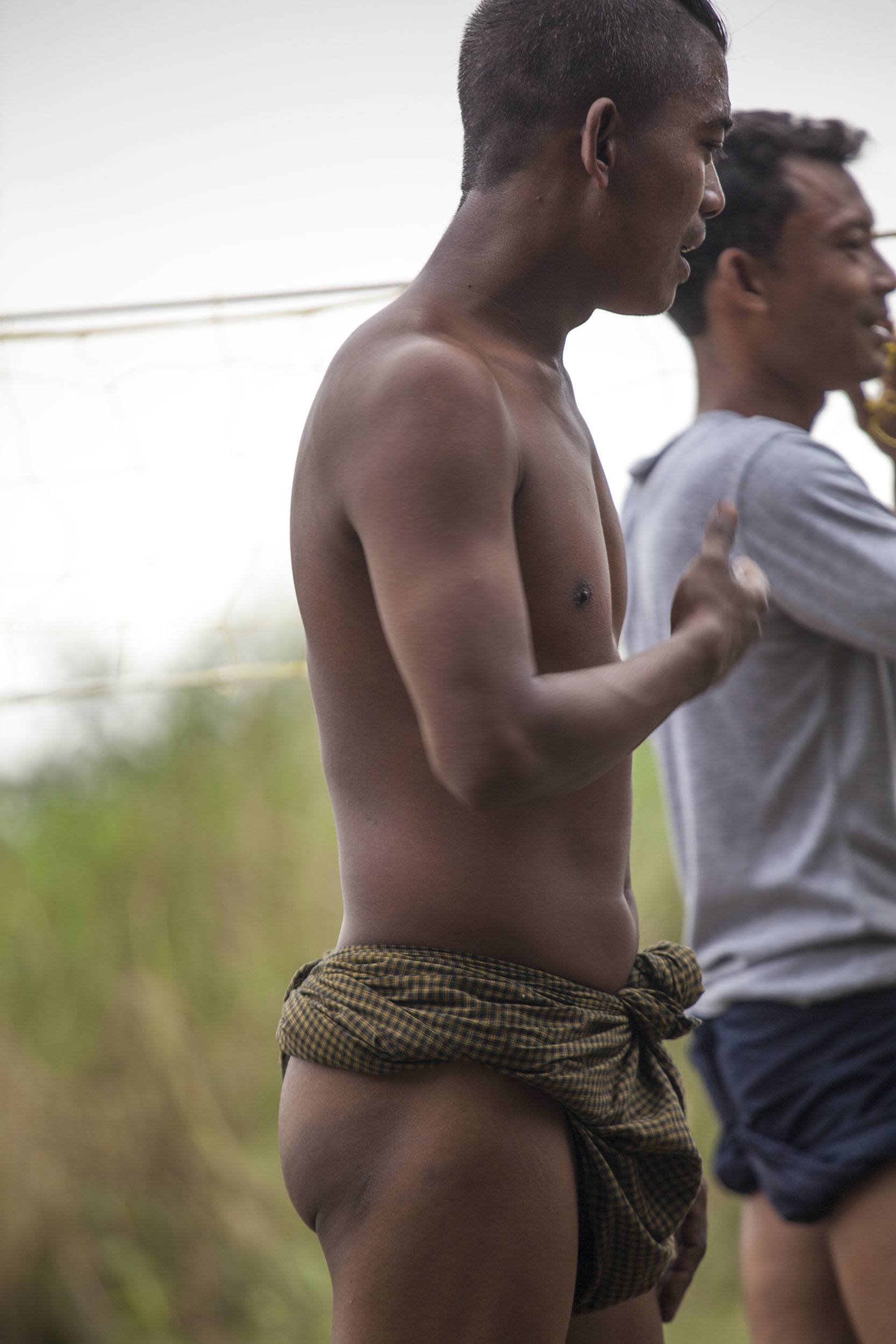 Men wearing longyi during a game of Chinlone in Mingun Myanmar