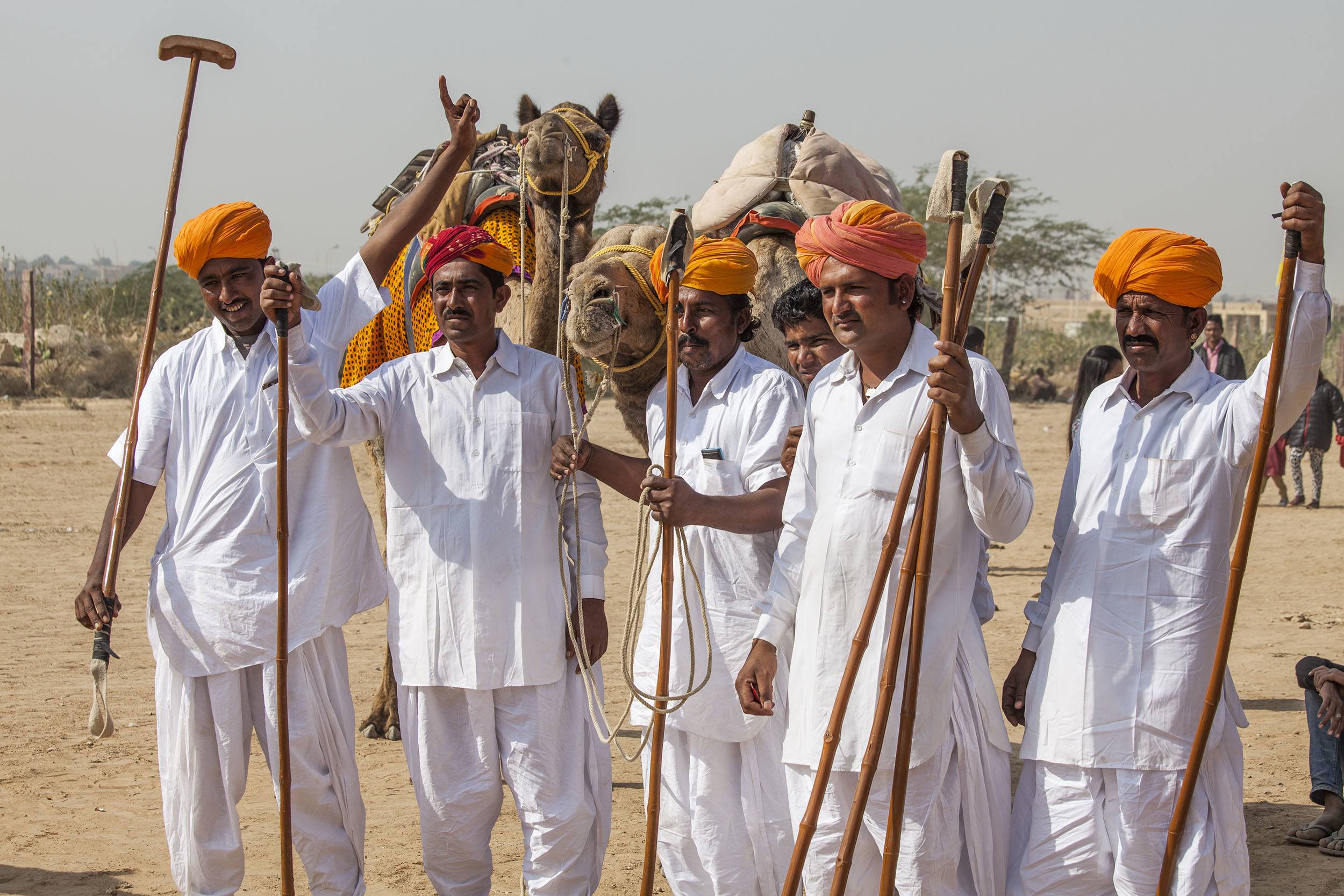 Men with orange turbans celebrating the Jaisalmer Desert Festival in India