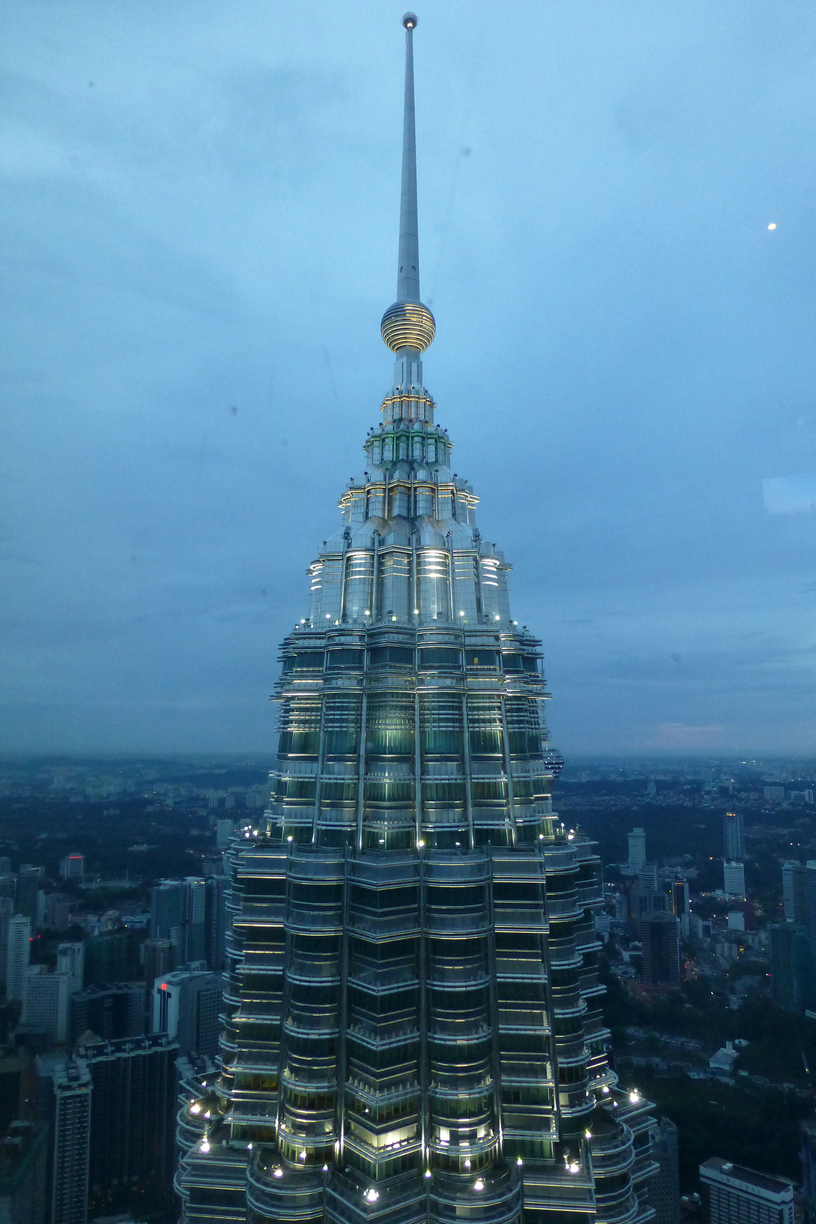 One of the Petronas Towers from the Observation Deck of the other at dusk in Kuala Lumpur Malaysia