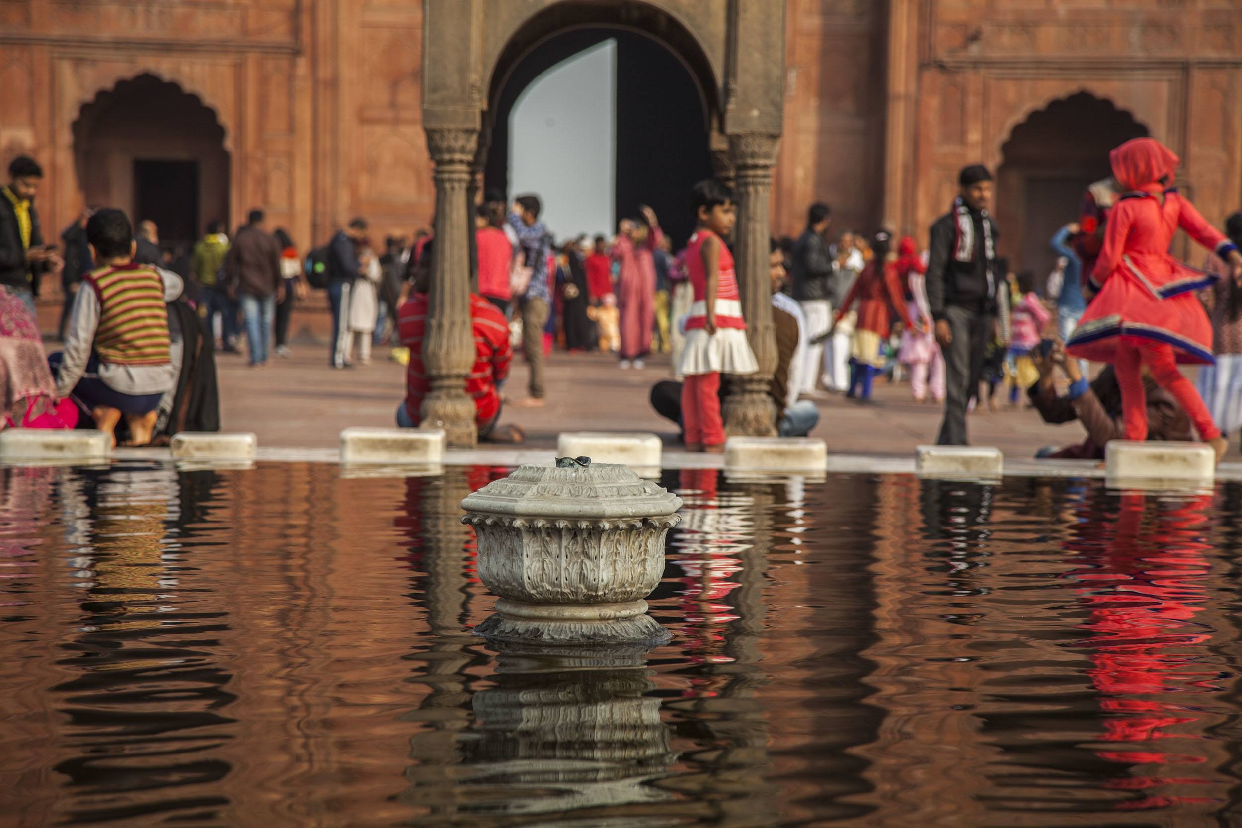 People near a fountain inside the Red Fort in Delhi India