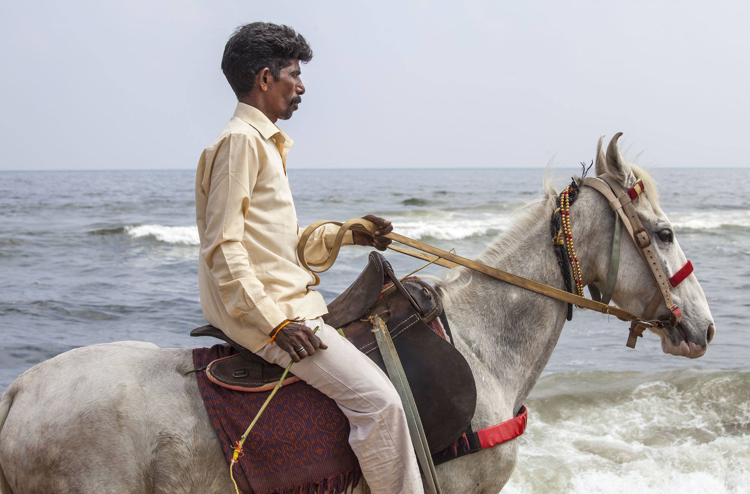 Riding a horse along the beach in Chennai India