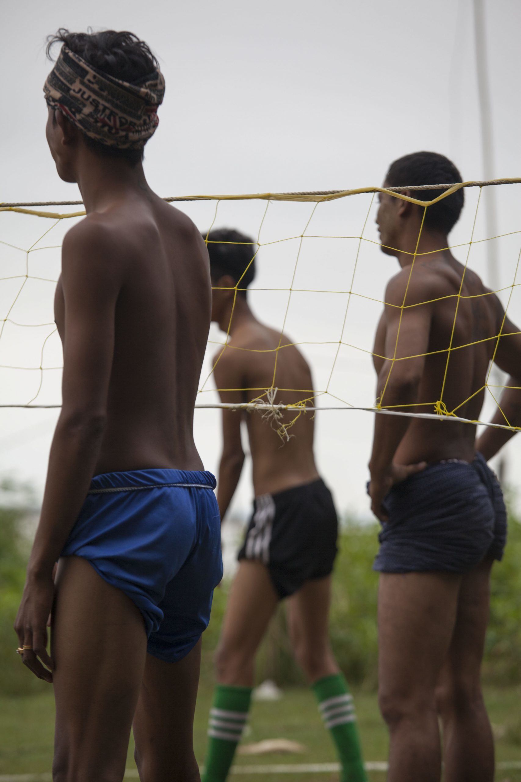 Shirtless men playing Chinlone in Mingun Myanmar