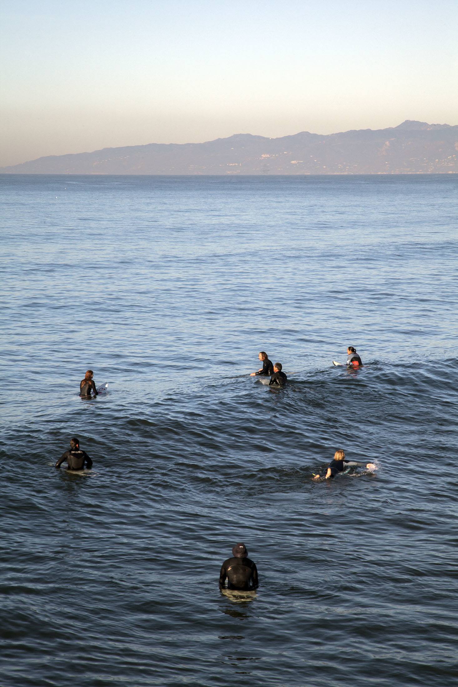 Surfers off the coast of Venice Beach Los Angeles USA