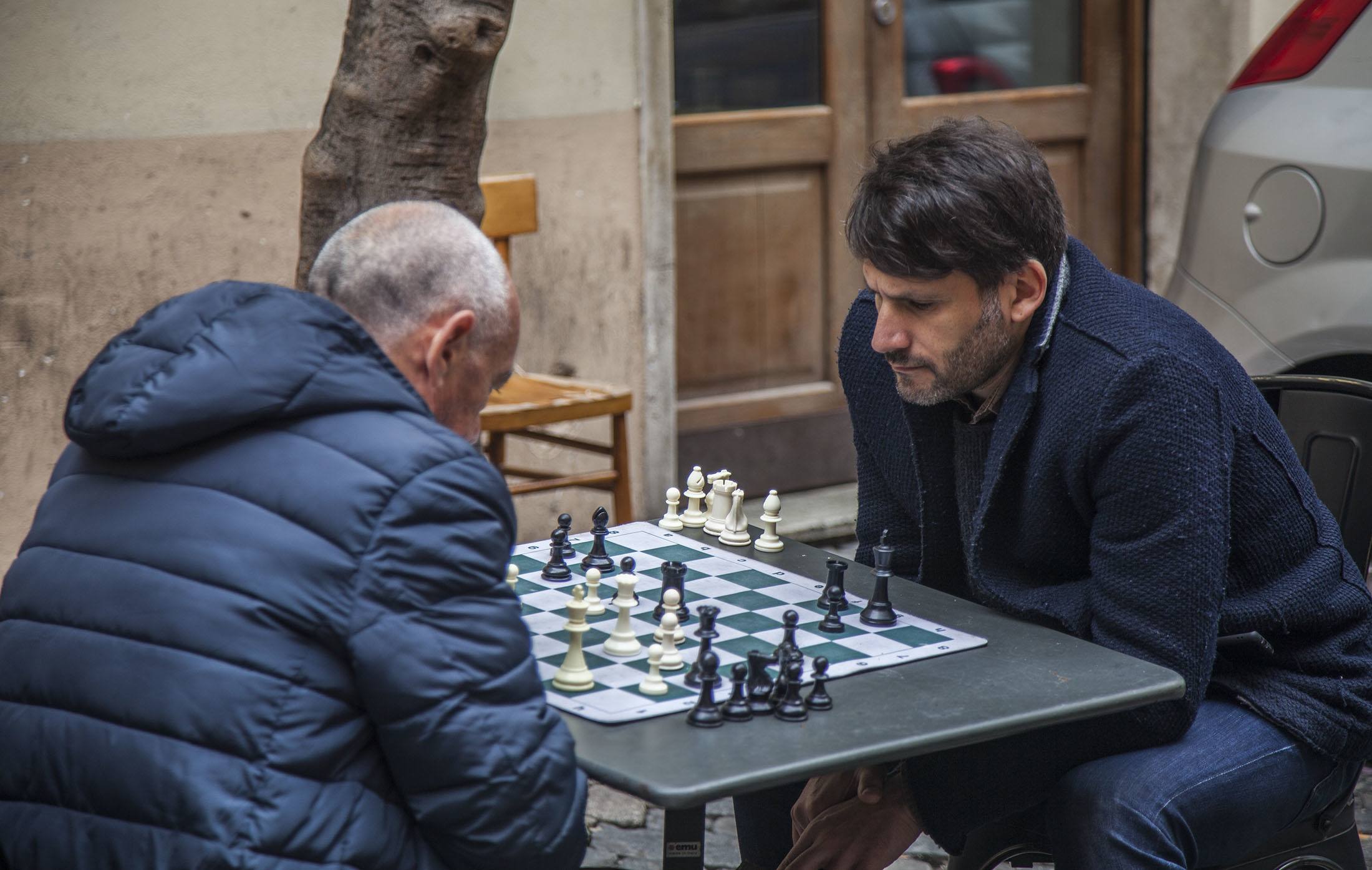 Two men playing chess in a piazza near Piazza Navona in Rome Italy