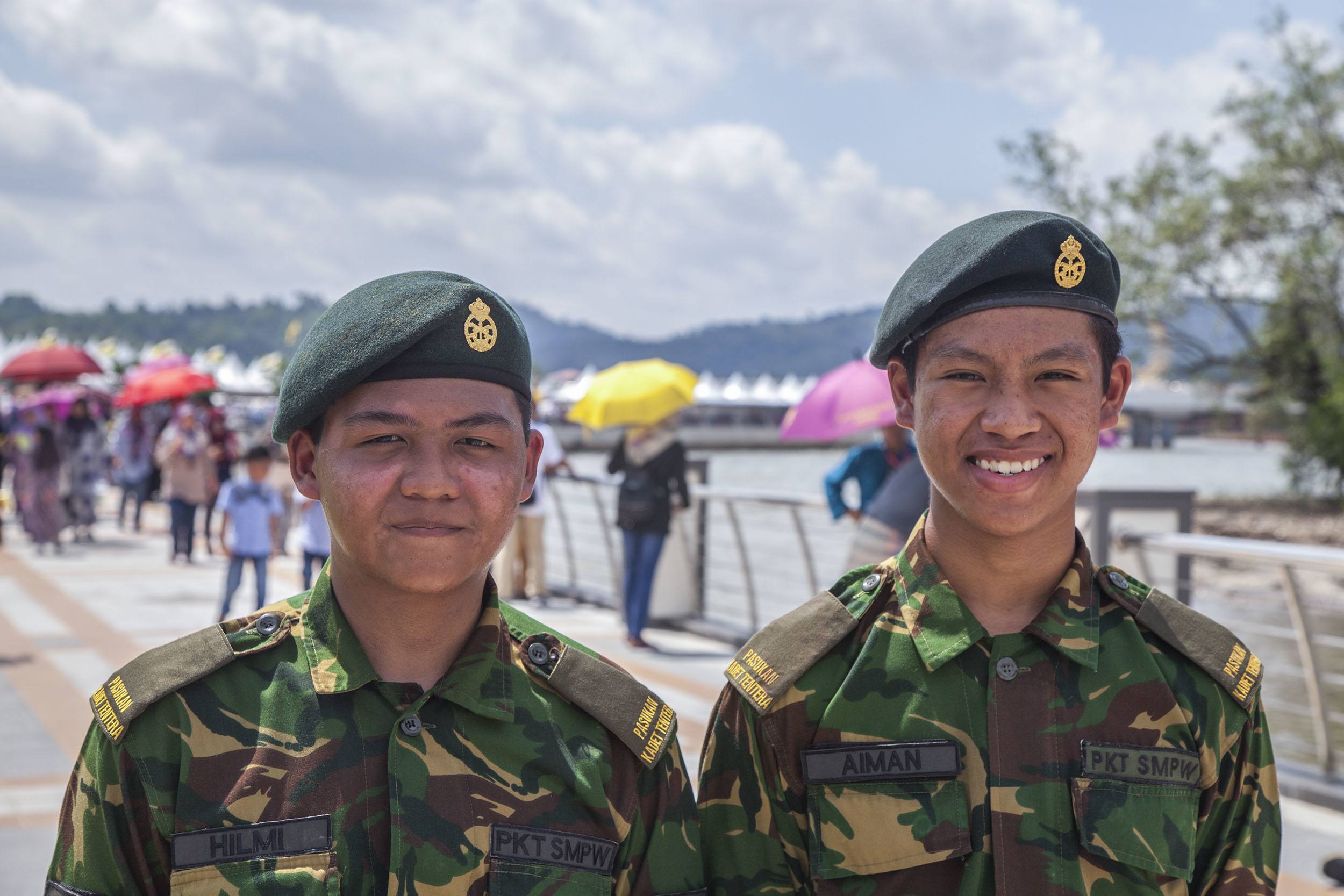 Two young Bruneian officers by the water in Bandar Seri Begawan Brunei Darussalam