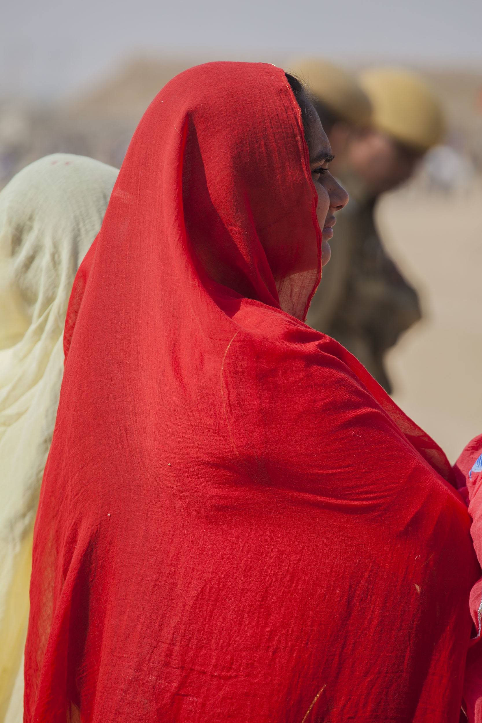 Woman wearing red shawl at the Jaisalmer Desert Festival in India