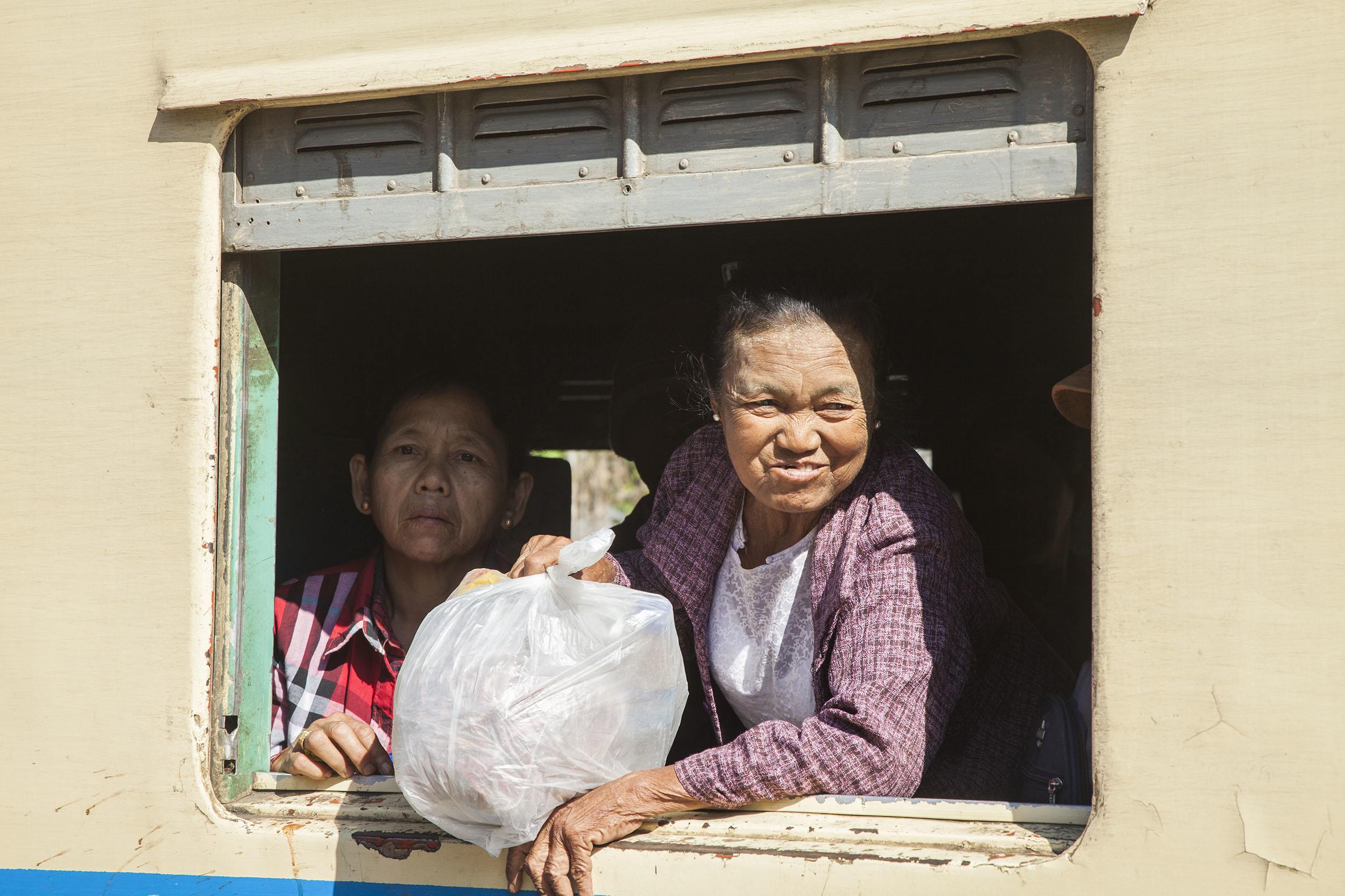 Women looking through the open train window en route to Inle Myanmar