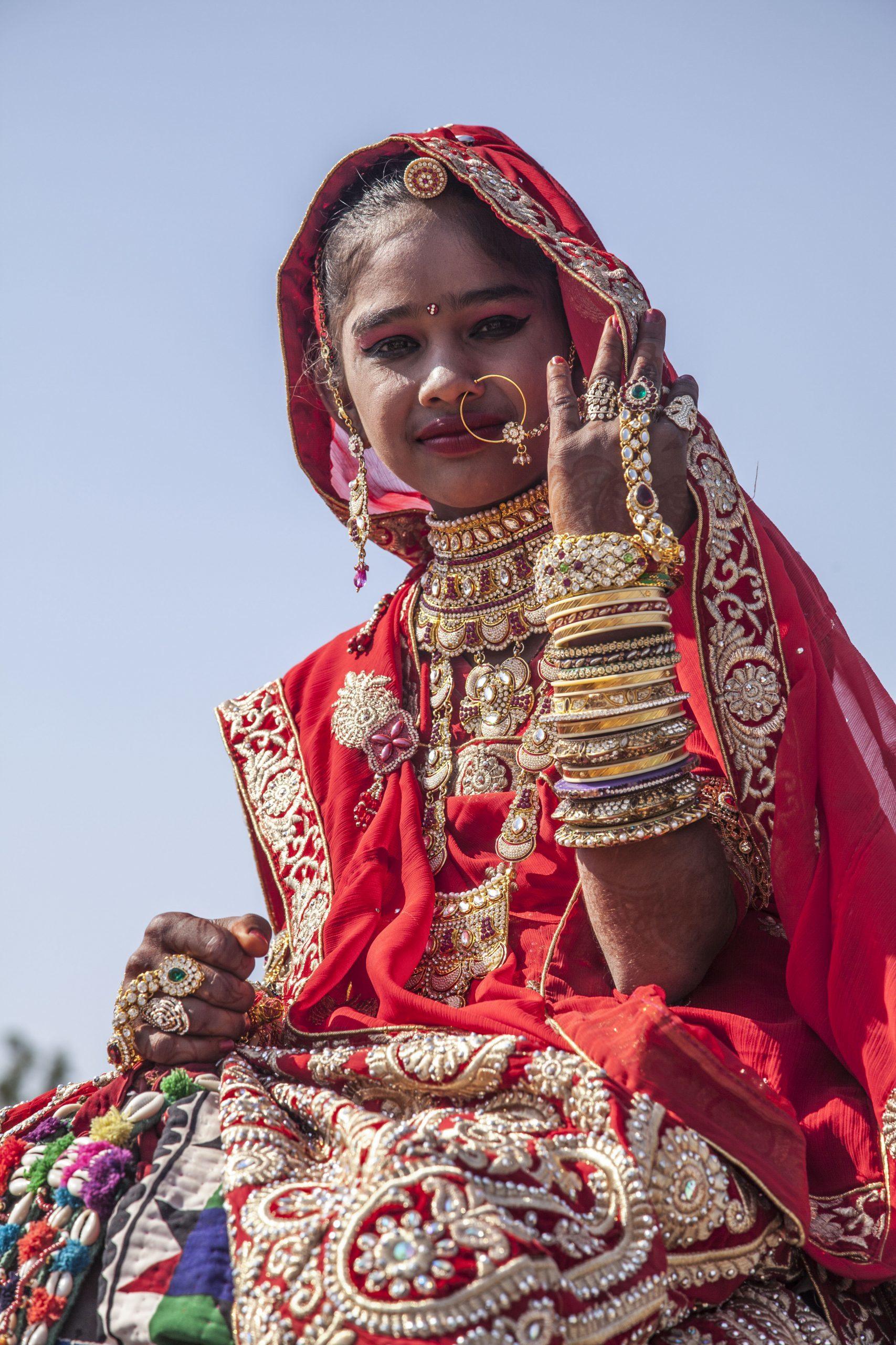 Young Indian woman with ornate decorations celebrating the Jaisalmer Desert Festival in India