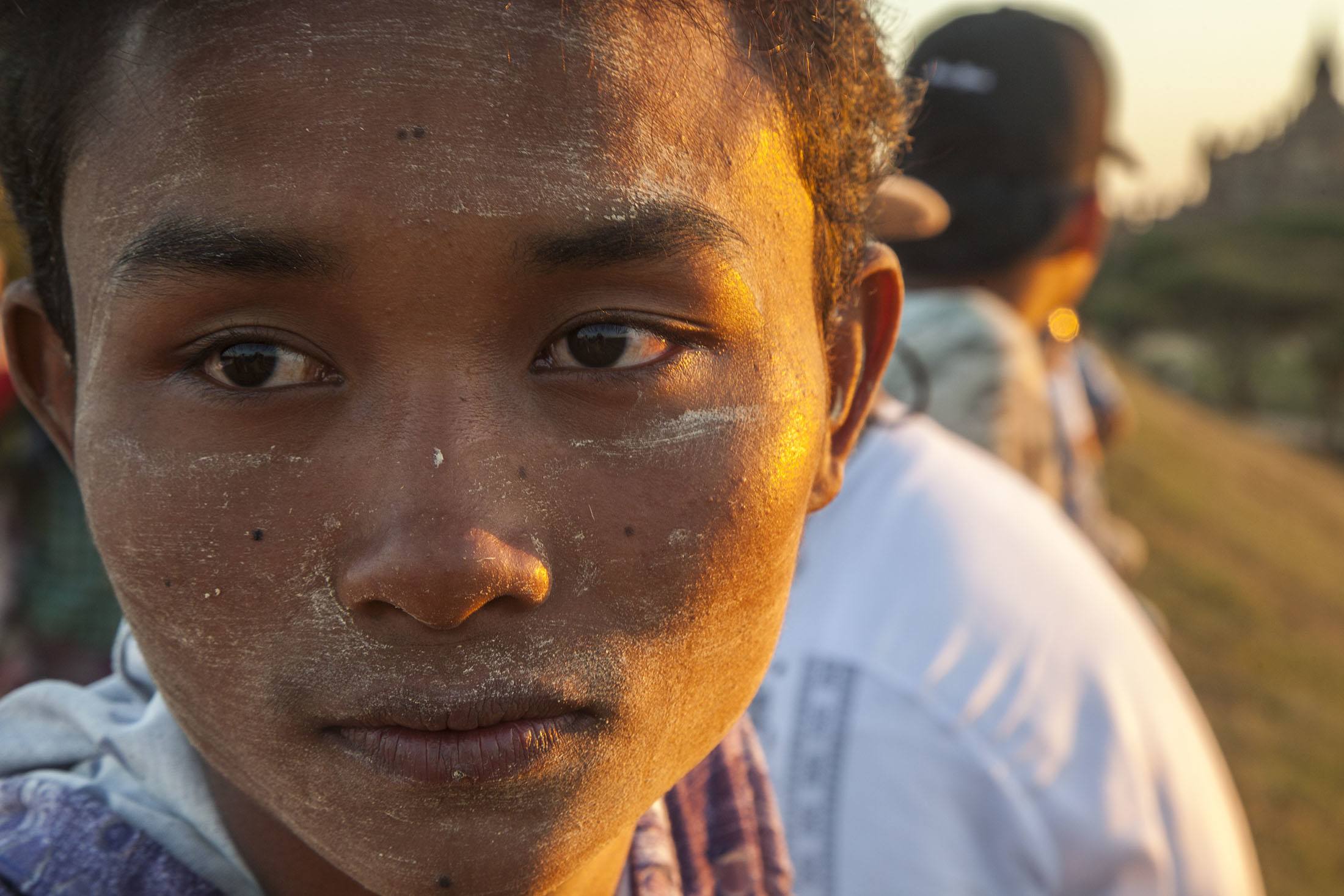 Young man watching sunset by a temple in Bagan Myanmar