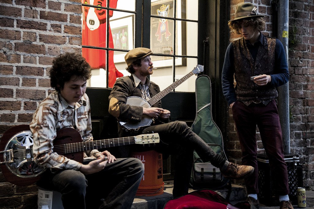 Young men playing live music on a street of New Orleans USA