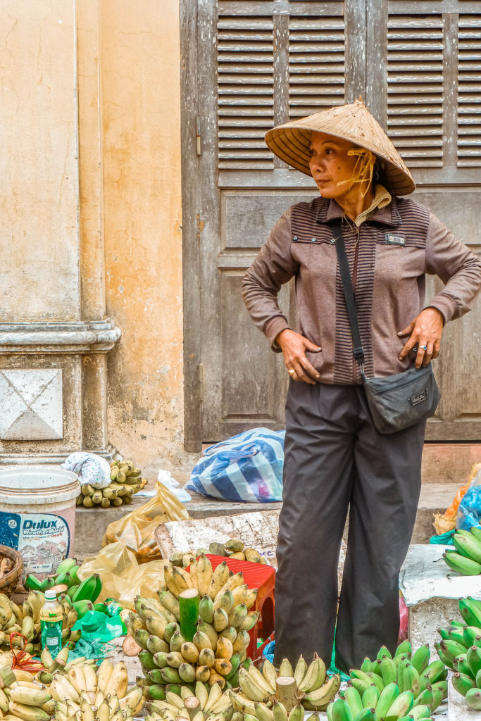 A woman selling fresh produce in Hoi An, Vietnam