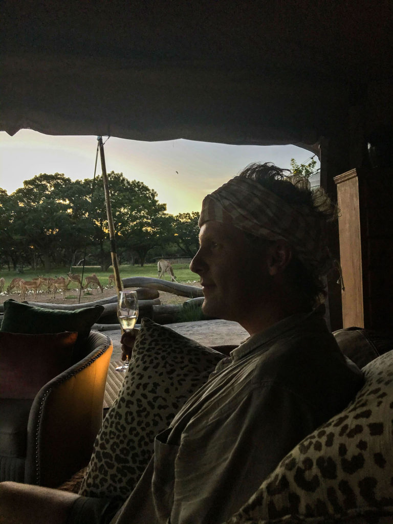 Ben sipping prosecco while watching the sunset at Wild is Life in Harare, Zimbabwe.jpg
