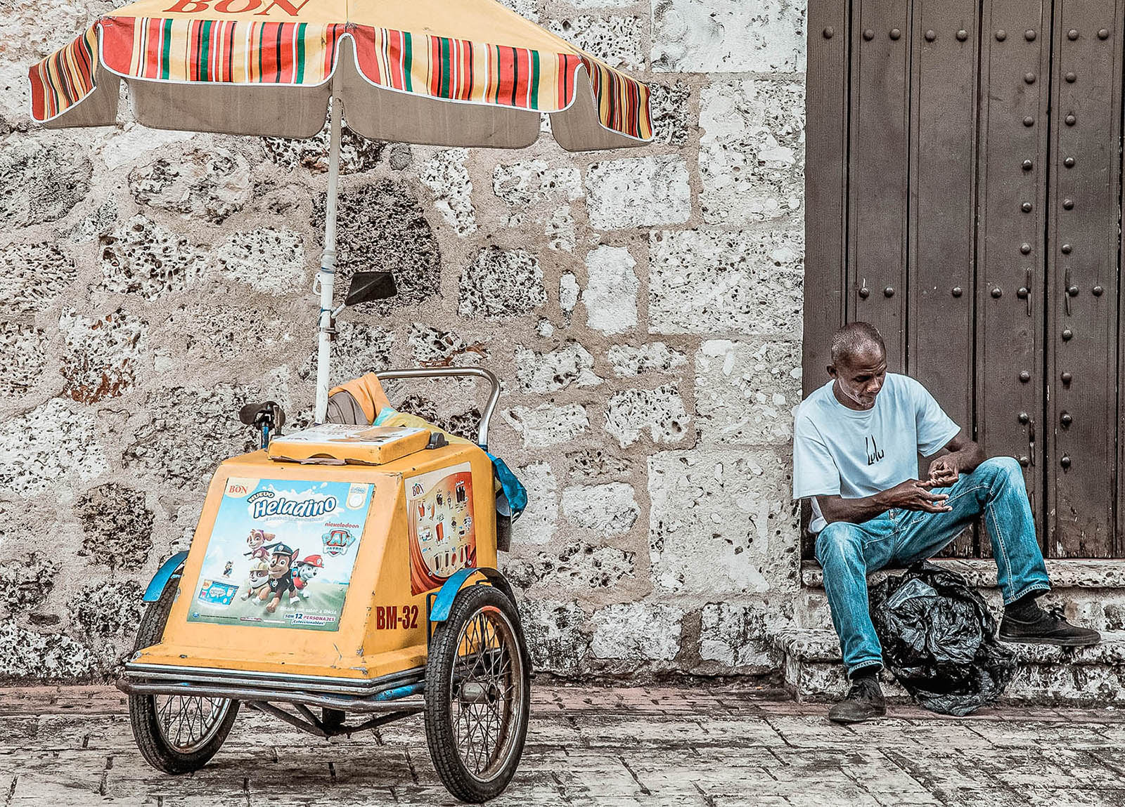 A man sitting outside the Museum of the Royal Houses Santo Domingo Dominican Republic copy