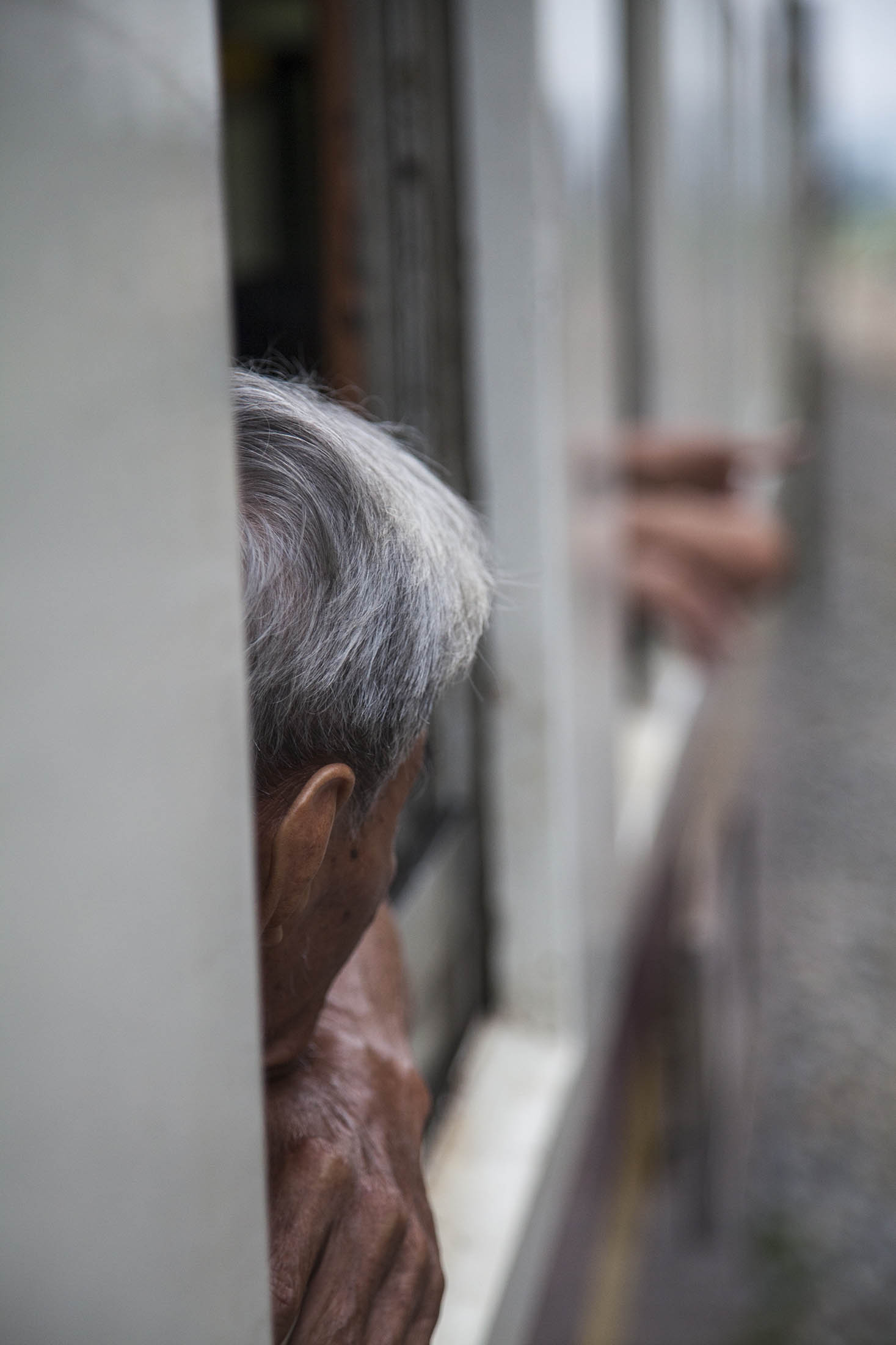 Back of man's head on train to Kanchanaburi, Thailand