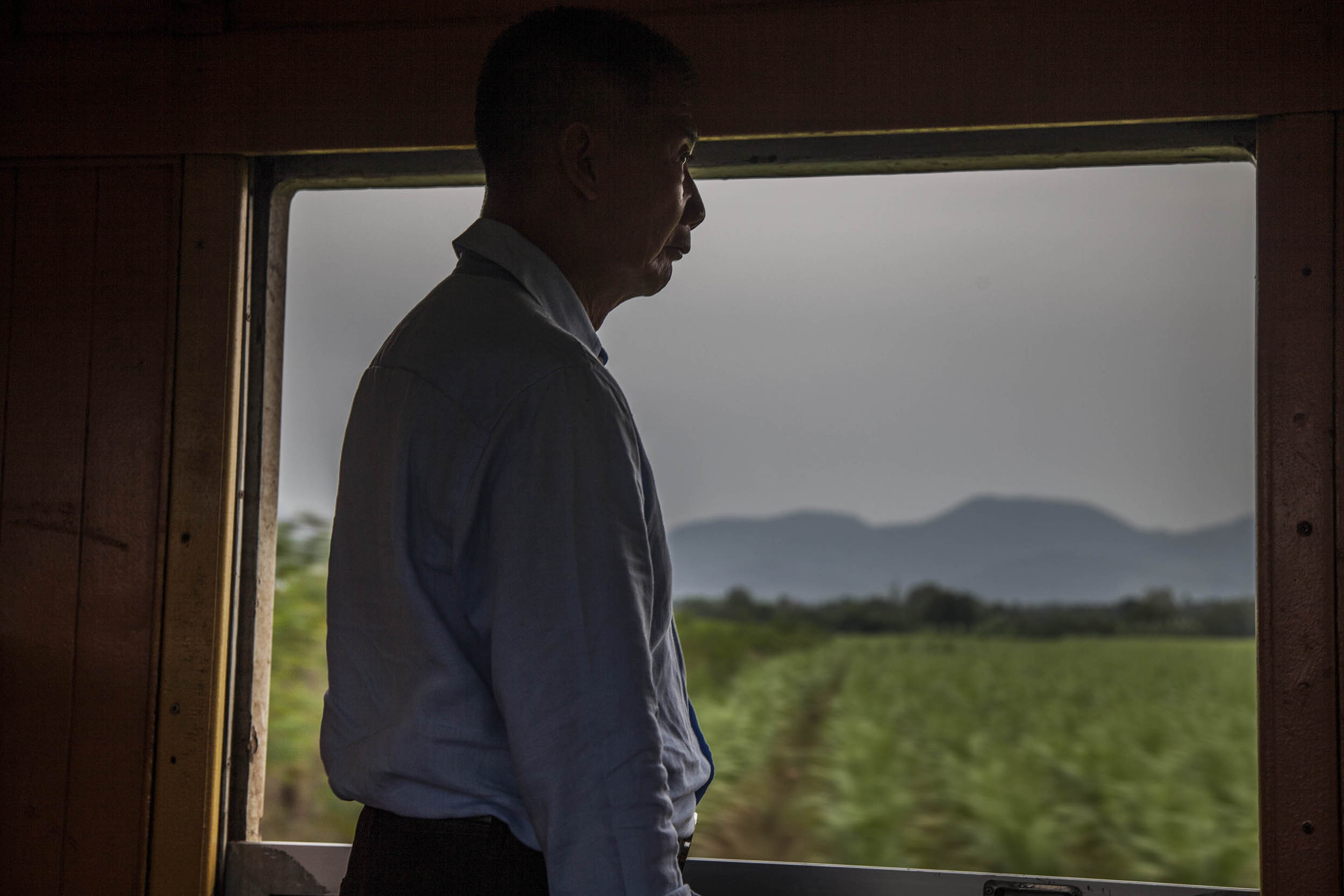 Man on train to Kanchanaburi, Thailand